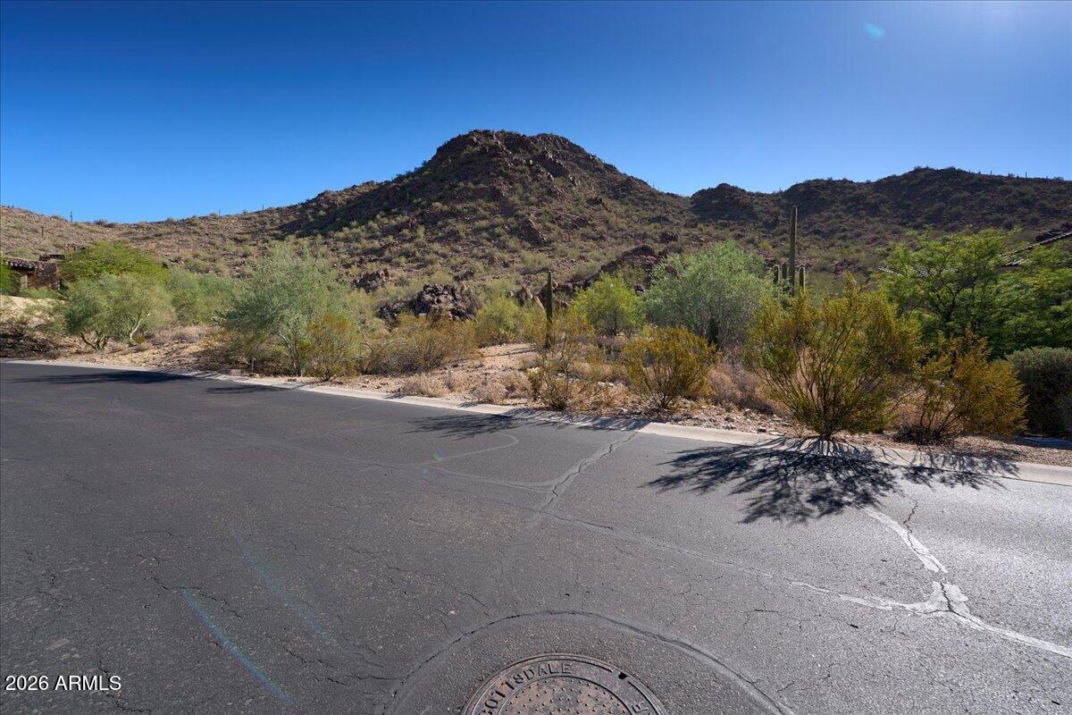 Rare opportunity to build in the prestigious double-gated enclave of The Canyons at Scottsdale Mountain. This 1.74-acre improved homesite offers breathtaking mountain, city light, sunset, and Camelback Mountain views. HOA-approved building plans are included, along with an approved 8-foot variance, providing a valuable head start toward construction. Surrounded by luxury custom homes and bordering the McDowell Mountains, the lot offers privacy, natural desert beauty, and an exceptional building envelope. Minutes from the McDowell Sonoran Preserve, world-class golf, dining, shopping, and Loop 101. Build your dream home in one of Scottsdale's most sought-after gated communities.