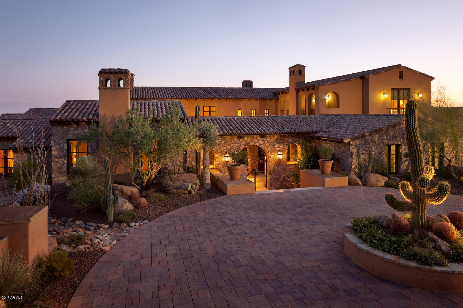 Stunning rural Mediterranean-style home in the Upper Canyon of Silverleaf! This 7693 sf property is on nearly 1.4 acres and is the ultimate in fine desert living.  Updated interior decor is transitional in the context of an Old World design. Upgraded features include a premium kitchen with Wolf appliances, wide plank Belgian white oak flooring, antique handcut french limestone fireplaces, decorative limestone detailing & copper stand-alone tub in master bathroom, and handsome milwork and wood beams throughout.  Thoughtful outdoor living spaces created at entry courtyard, covered back patio, and 2 cabanas that book-end the pool – nearly 2800 sf of total outdoor covered space! Floorplan also features a 660 sf two-room guest house off the entry courtyard, a bonus room with wetbar & view deck, walk-in wine room, separate entry executive office, master suite on the main level, and 4 car garage.  A mammoth 3000 lb singe stone wishing well adds whimsy to the outdoor space. Home also includes Savant whole house automation system, Crestron lighting, 6 fireplaces plus firepit, 2 outdoor showers, hot water recirculation pump and much more. Great location providing both estate home privacy and convenience with two manicured parks just a block away.  This is the perfect home for a buyer who wants elegance but yet still wants a sense of neighborhood.