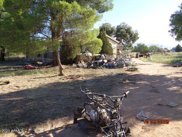 Here is an opportunity!! This double wide manufactured home sits on 2.74 acres and it is totally fenced. There are great views of the surrounding mountains. The home has an Arizona room on the front anda covered patio in the back. There are also 2 sheds. 1 might be large enough to park a small vehicle in. This is a fixer and an AS IS sale.