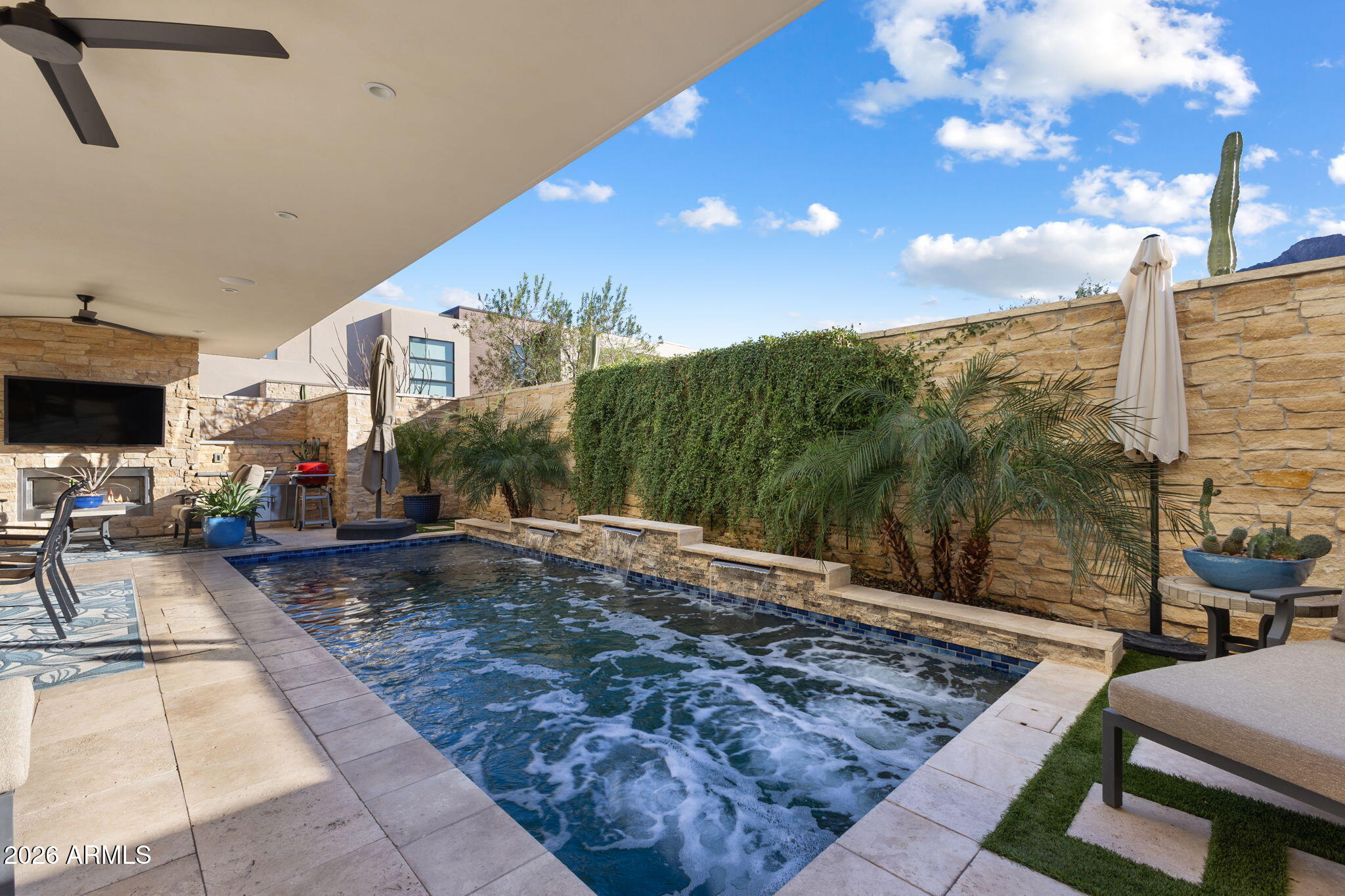 An rare luxury villa nestled within the prestigious Mountain Shadows Resort, offering refined single-level, first-floor living in a guard-gated luxury community with 24-hour security and concierge services. This private, energy-efficient residence features a heated private pool, southern exposure, and massive, unobstructed views of iconic Camelback Mountain, delivering a truly elevated desert lifestyle.

A private courtyard entry welcomes you into an open, flowing floor plan designed for seamless indoor/outdoor living. The elegant entry opens to a spacious great room with 10-foot ceilings, limestone floors, Sierra Pacific casement windows, and 9-foot bi-fold doors leading to an 800+ SF private patio with indoor and outdoor fireplaces.

The chef's kitchen is both striking and functional, featuring a massive island, 48" Wolf dual-fuel range, 48" Sub-Zero refrigerator, wine bottle tower, Asko dishwasher, and distinctive custom cabinetry. Additional highlights include Savant home automation, motorized Lutron shades, custom closets, and professional interior design throughout.
The residence offers three beautifully designed bedrooms and three bathrooms, along with a private two-car driveway with enough space to park four cars and guest parking spaces right across the home, and epoxy-finished garage equipped with a ChargePoint electric vehicle charger, and motorized overhead storage. Modern efficiency is enhanced by a tankless gas water heater.

Residents enjoy exclusive access to world-class resort amenities to Mountain Shadows Resort with two pools, championship golf course, tennis courts, the Sanctuary Spa, a 4,500-square-foot fitness center with group classes, and on-site artisanal diningall within one of Paradise Valley's most coveted luxury communities.