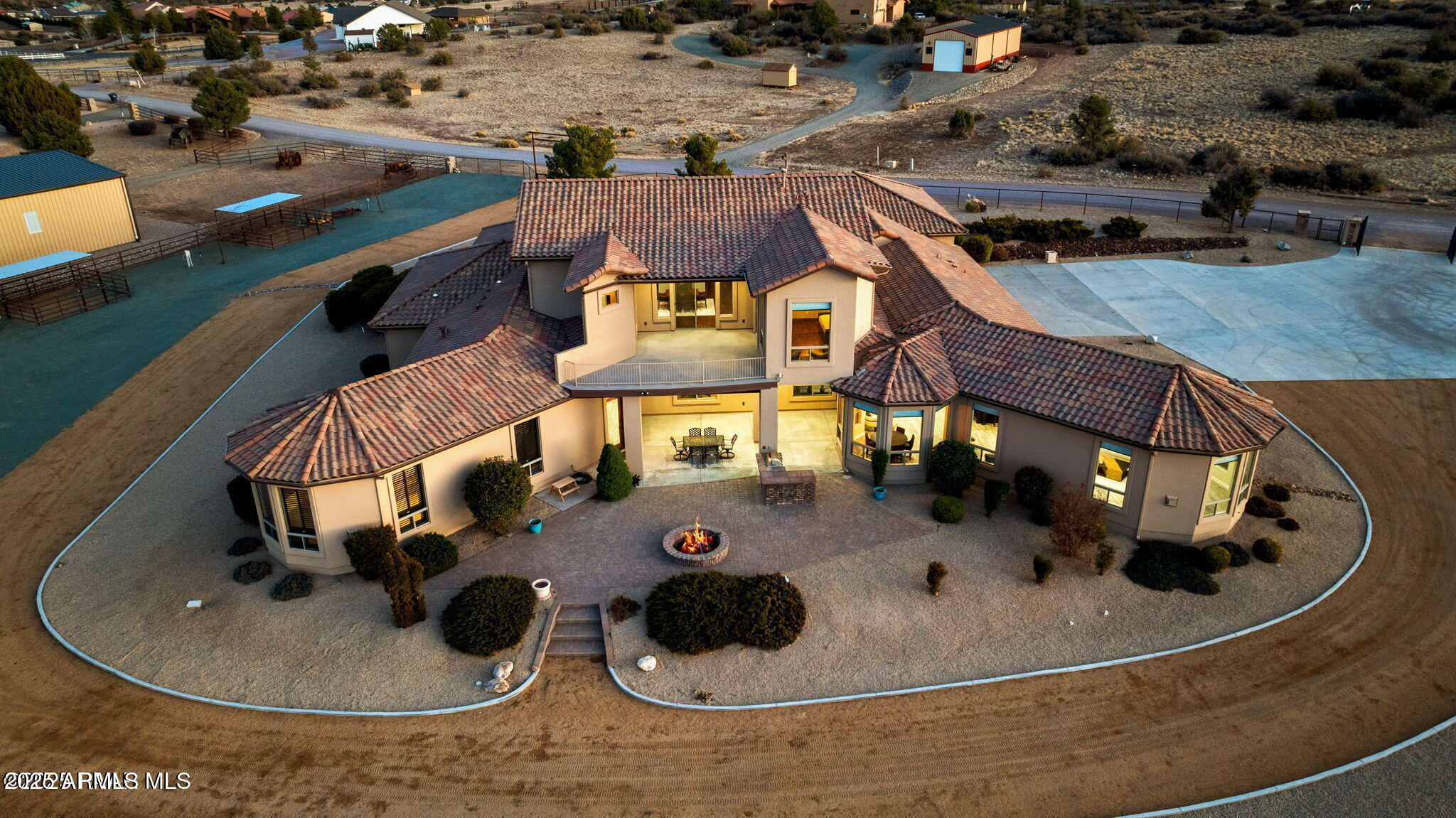 Luxury living with world-class equestrian facilities. Fully remodeled &privately gated, it offers breathtaking views of Mingus & Granite Mountains. Set on 3.69 fully fenced acres, w/ Approx 5,000 sq.ft main living. featuring 5 beds, 5 ¾ baths, soaring ceilings, plank tile flooring, custom cabinetry, 234-bottle wine wall, built-in bar, & RV garage. Primary suite is a retreat w/ fully updated bath. Addl- 4 ¾ are all fully remodeled Outdoor amenities include a pro-level roping arena, 3,200 sq. ft. barn with a mare motel, five 16x16 stalls, large tack room w/ a hidden 10' door, & three RV hookups w/ water, electricity & horse stalls. Arena features roping boxes, chute, sand-packed surface, cattle area w/ sorting gates & feeding stations. Rare luxury ranch in a prime Arizona setting