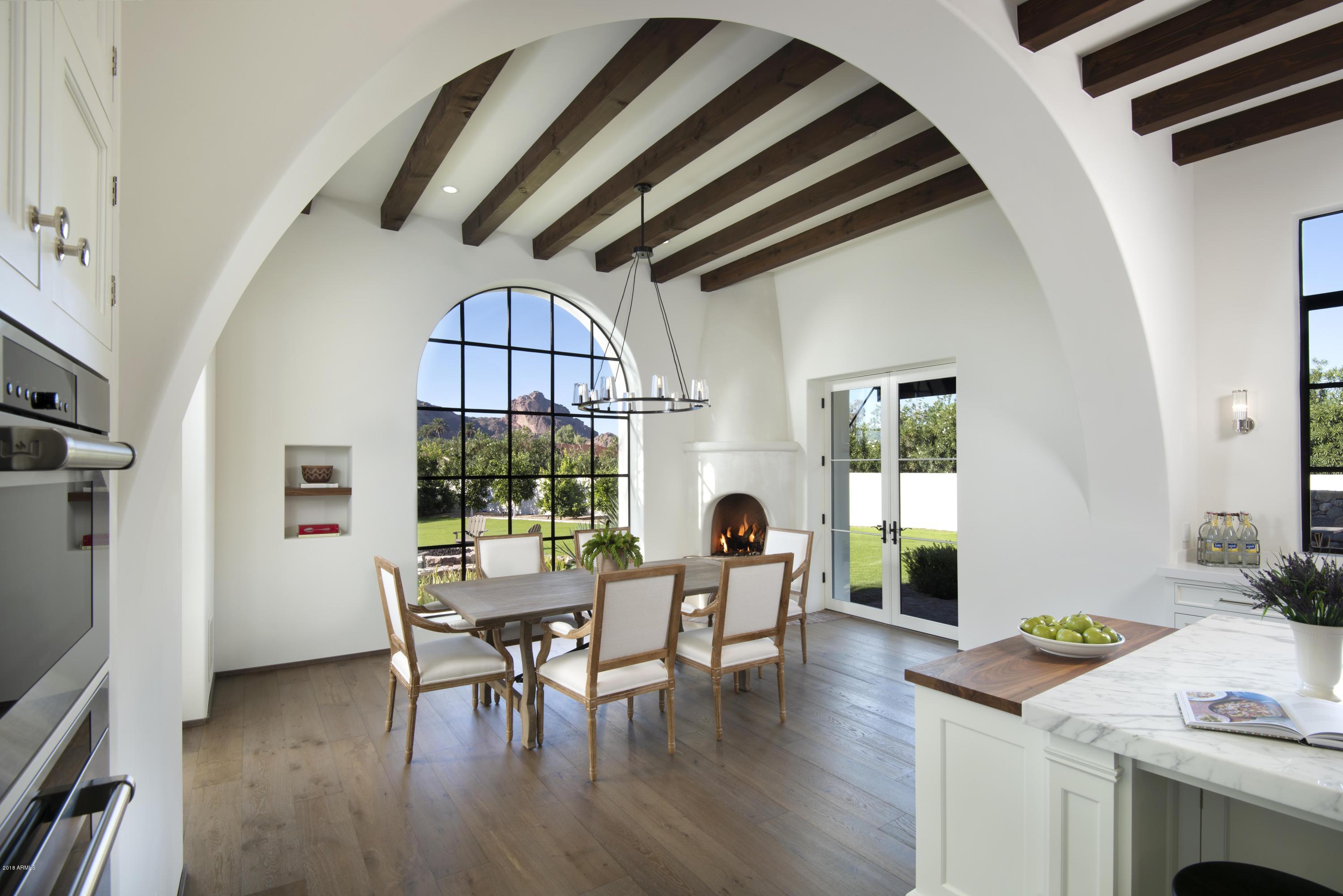 This absolutely charming new construction with uncompromising quality and rich in architectural detail showcases stunning views of full Camelback Mtn seen thruout the home from large elegant steel windows. Designed by Architect Don Nulty of Santa Barbara it has handcrafted Douglas fir ceilings, groin vaulted hallways, rondel windows, hand forged ironwork + doors from Spain.The gourmet white kitchen opens to a breakfast rm with corner fireplace +spacious family rm. There is a beautiful master with white marble bathrm+ huge custom closet, a library, attached guest wing,2 family rms,2 laundry rms + exercise rm.The very private gated entry has a large flowering courtyard and the backyrd has views, lush lawns,reclaimed brick, stacked stone walls, intimate seating areas,citrus orchard, pool+spa. This 5 bedroom Spanish Colonial Revival built by Casa Blanca Builders captures the warmth, charm and graciousness of the look of Santa Barbara.