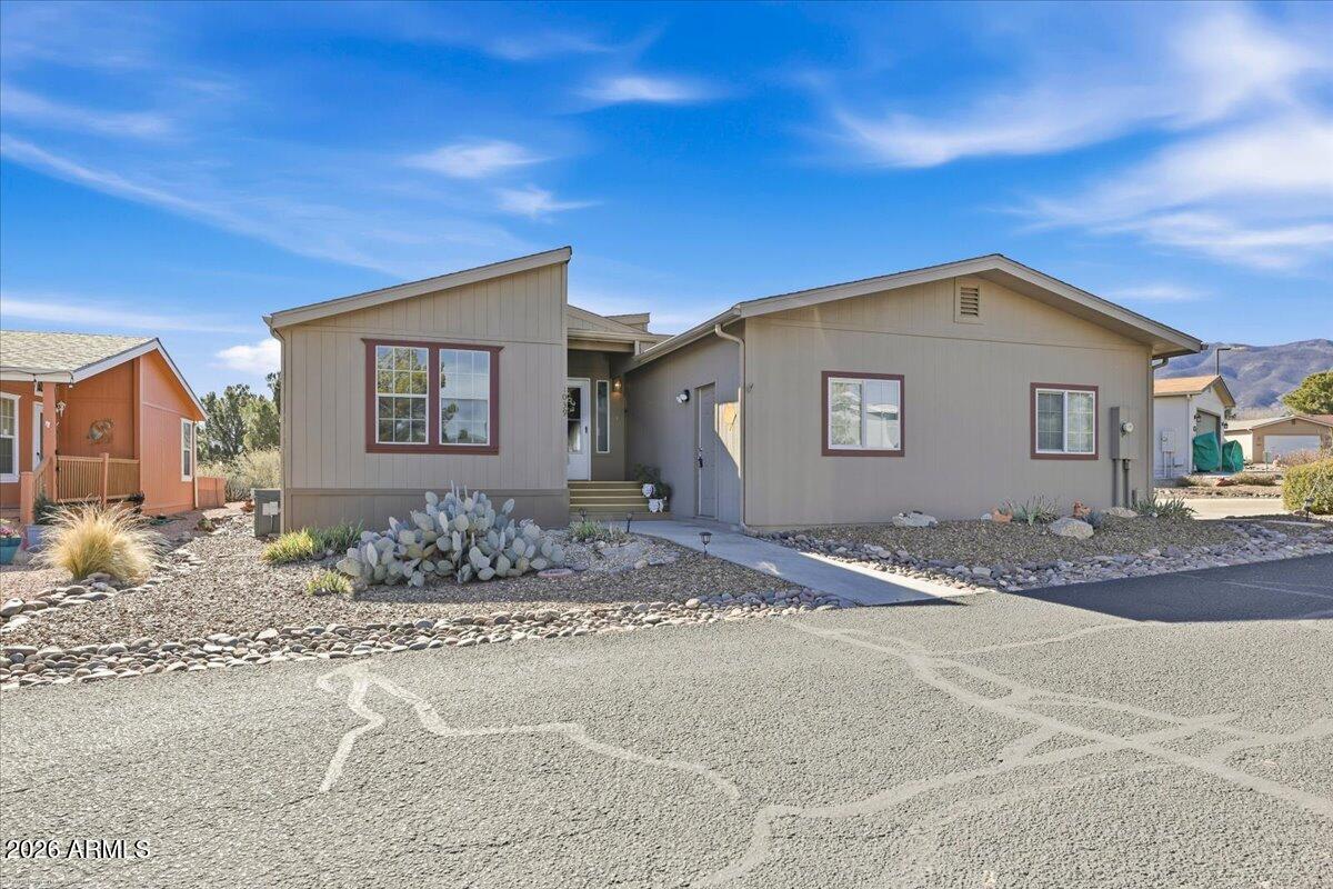Wake up to golf course views on the 8th fairway from this 2-bedroom, 2-bath manufactured home in a 55+ community on leased land. The back porch provides a serene vantage point overlooking the greens-perfect for morning coffee or evening sunsets. A great opportunity to enjoy a home loved by one owner and low-maintenance living in a desirable golf-course setting.  This property offers an extended driveway to offer additional parking.