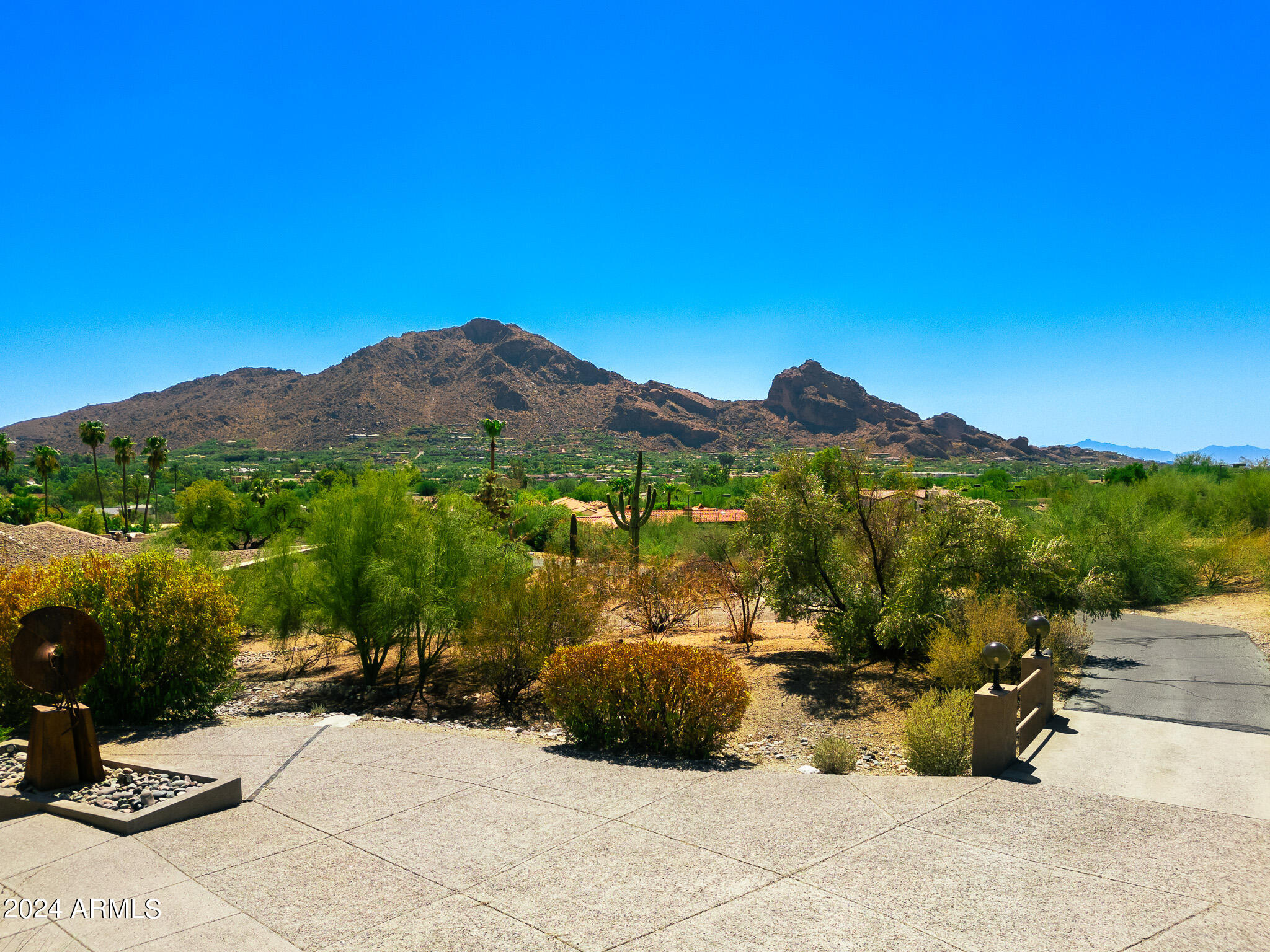 This breathtaking 1.26-acre, NON-HILLSIDE LOT in Paradise Valley is located on the south slope of Mummy Mountain, offering panoramic views of Camelback Mountain, Mummy Mountain, downtown Phoenix, and the East Valley including Four Peaks. The existing 4,759 sq. ft. contemporary home features 4 bedrooms and 3 bathrooms, with potential for expansion to include a car collector's garage or guest quarters.