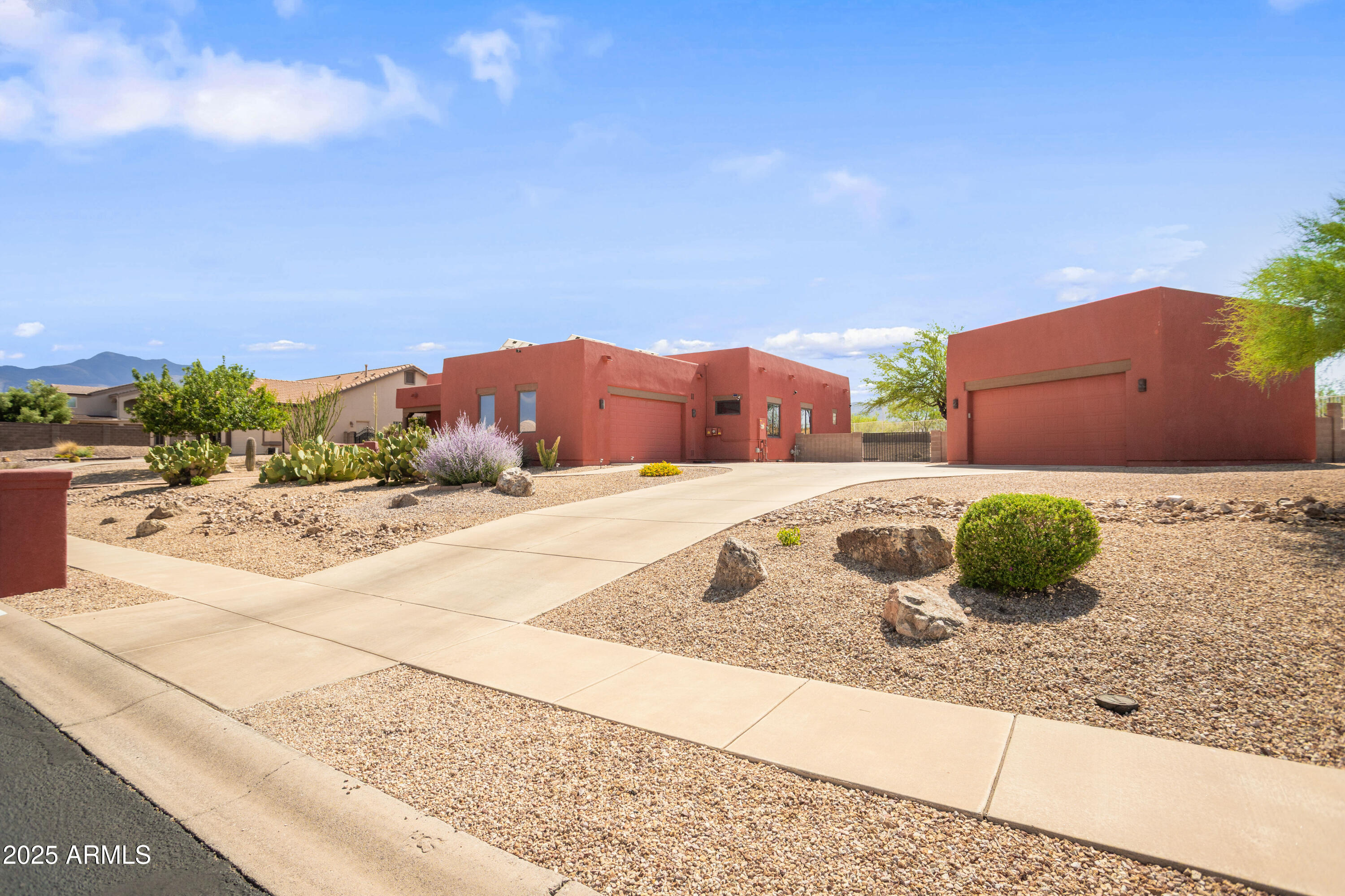 Discover this elegant custom Walston home in Sierra Vista: a 4 bedroom, 3 bath spanning 2,819 sqft including a 250 sqft heated & cooled workshop/gallery converted from the back portion of the detached garage. The home features formal living and dining areas, a great room with fireplace and custom blinds, and an updated kitchen with stainless steel appliances, abundant cabinetry, and quartz counters. Vaulted ceilings and hardwood-style ''Vegas'' floors flow throughout, complemented by dual-pane windows for efficiency and a brand new hot water heater. Recent updates include fresh interior/exterior paint, upgraded landscaping, and modern lighting. Outside, resort-style, low-maintenance landscaping reveals panoramic mountain and city-light views.