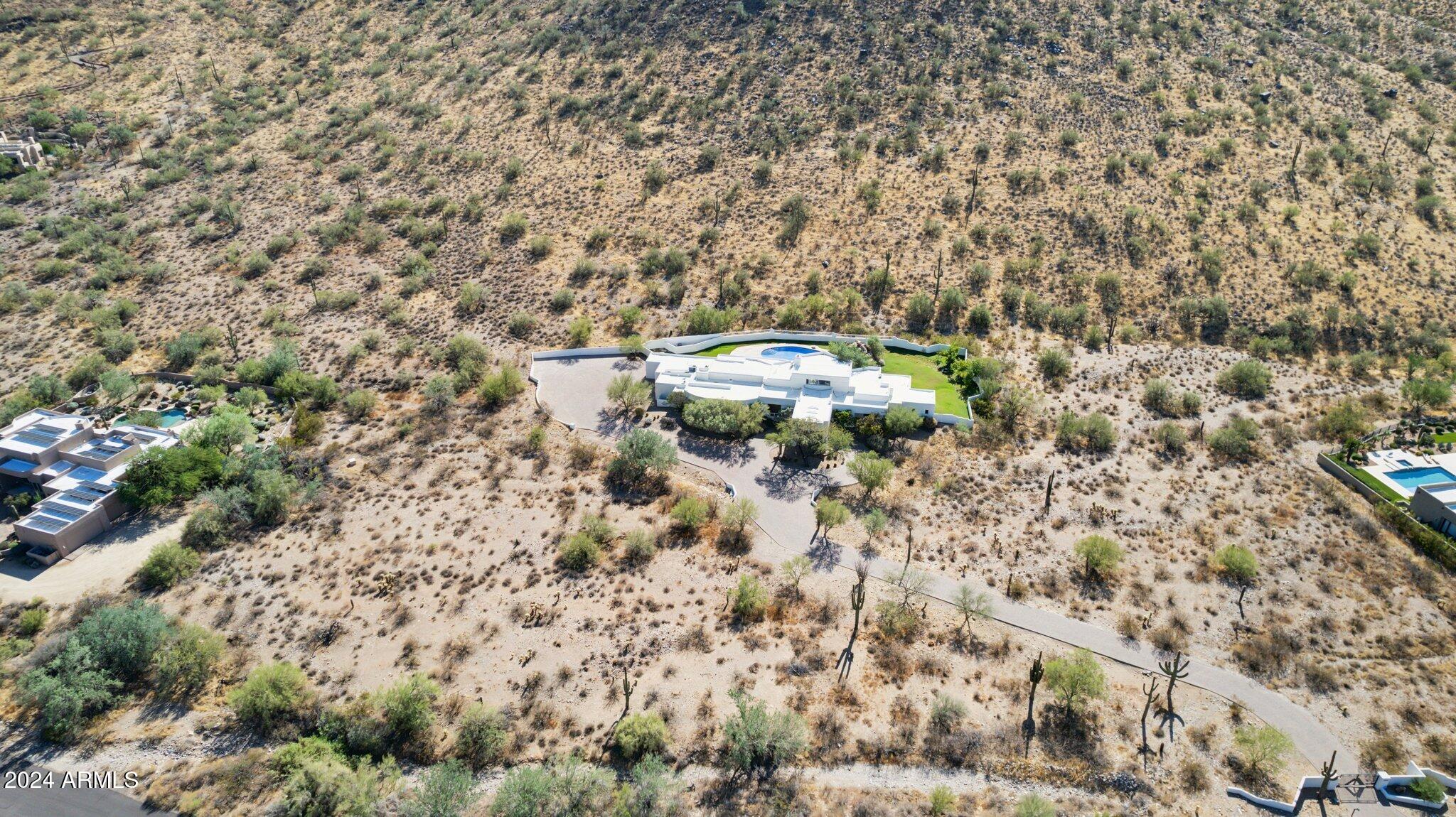 REMODEL OPPORTUNITY! 

Interested in a large private desert estate nestled at the base of a mountain that is ready for you to make your own? Located in North Scottsdale, just a short drive to the Loop 101 Freeway and all the amenities such as the Scottsdale Quarter & Kierland Commons is an opportunity to acquire a custom home situated upon approximately 19 acres. The home offers four bedrooms, a flex room, six bathrooms, a towering two-sided fireplace, with beautiful desert and mountain views. Offered at $3,900,000.00 below recent appraisal.