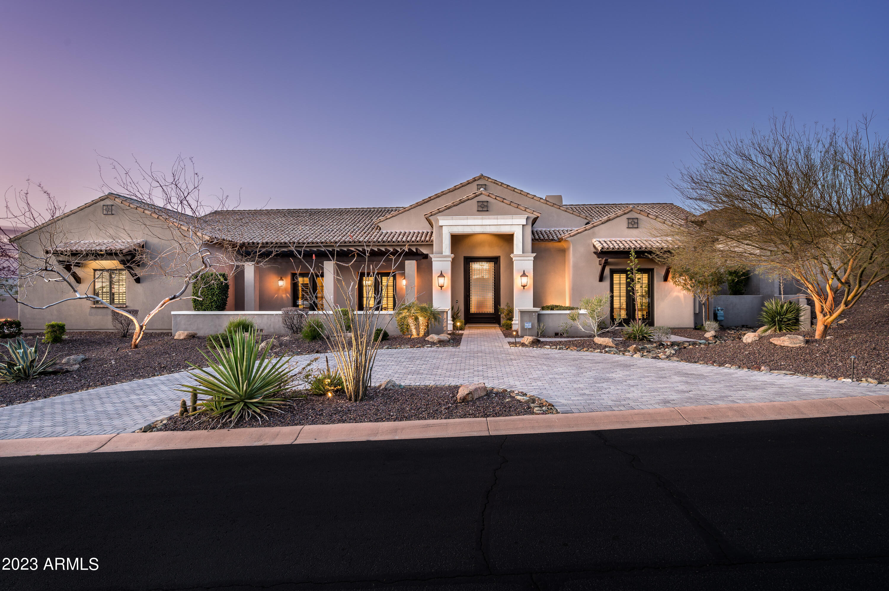 Beautiful custom home built by Mark Steimer delivers pride of ownership location with top rate curb appeal in the desirable North Scottsdale gated community of Sierra Hills. Northern exposure and unobstructed mountain views welcome through large automated sliding doors as you enter through the large iron front door. Soaring vaulted ceilings, multiple masonry style fireplaces, wood beams,  wood floors, custom cabinetry, high end appliances, a spa bathroom, and high end finishes abound throughout. A spacious and extended 4 car garage, large driveway, and quiet cul-de-sac make this home ideal for a family or a car enthusiast. This large but comfortable split master floor plan with 5 bedrooms and 4.5 bathrooms will certainly impress. Immaculately built and maintained. Shows as new!