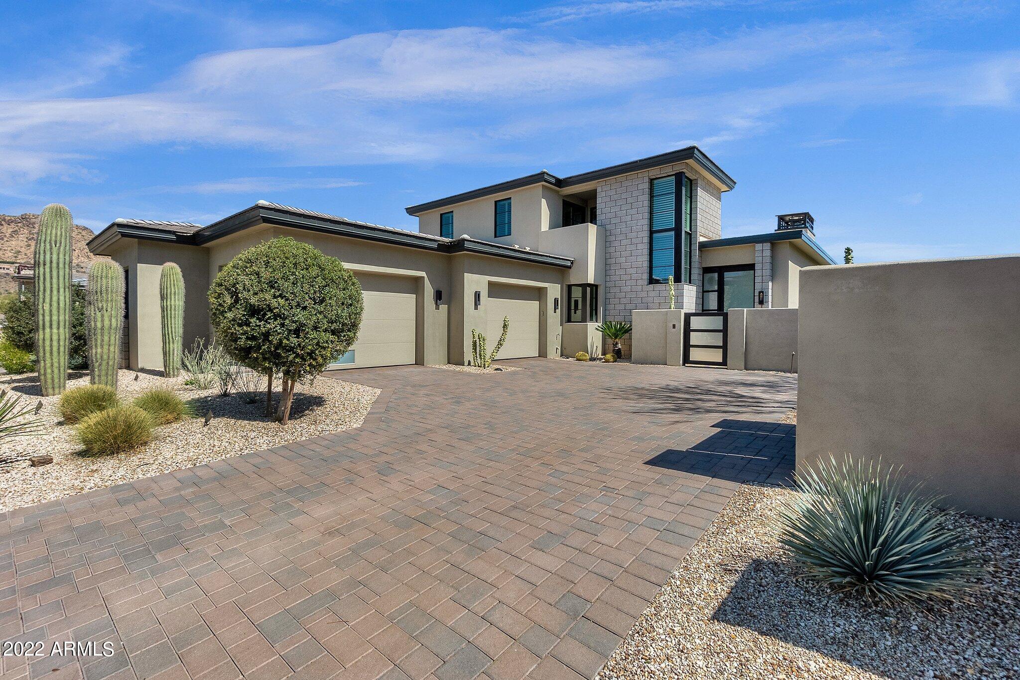 NESTLED AT THE BASE OF THE VALLEY'S MOST ICONIC NATURAL LANDMARK, CAMELBACK MOUNTAIN, THE VILLAGE AT MOUNTAIN SHADOWS IS SITUATED IN THE HEART OF PARADISE VALLEY. BUILT BY CULLUM HOMES AND DESIGNED BY THE RENOWNED ARCHITECTURAL FIRM, CANDELARIA DESIGN ASSOCIATES, THIS BEAUTIFUL TWO-STORY HOME OFFERS 3 BEDROOMS, 3 FULL BATHS, 1 POWDER ROOM AND OVER 4,000 SQ FT OF LIVING SPACE. BEHIND THE STEEL FRAMED GLASS DOOR, SOLID HARDWOOD FLOORING GUIDES YOU TO THE EXPANSIVE LIVING ROOM AREA AND DINING ROOM SHOWCASING A FLOOR TO CEILING BRICK FIREPLACE AND RETRACTABLE GLASS WALLS, EFFORTLESSLY CAPTURING INDOOR AND OUTDOOR LIVING. THE KITCHEN BOASTS STYLED WOLF STAINLESS STEEL APPLIANCES, SUBZERO REFRIGERATOR, A WATERFALL EDGE QUARTZ CENTER ISLAND, GAS STOVE TOP AND RANGE HOOD, SLEEK WHITE AND WALNUT CABINETS AND EAT-UP BAR SEATING. THE KITCHEN OPENS TO THE IMMENSE GREAT ROOM AREA ALLOWING AN ABUNDANCE OF LIVING SPACE. THE MAIN LEVEL MASTER RETREAT OFFERS A LAVISH BATH QUARTERS WITH SEPARATE TUB, PRIVATE TOILET ROOM, DUAL SINKS, WALK-IN SHOWER WITH MULTIPLE SHOWER HEADS, HUGE WALK-IN CLOSET AND GORGEOUS VIEWS OF THE BACK YARD AND PARK. UPSTAIRS, A GENEROUS LOFT AREA WITH SLIDING GLASS DOORS LEADS OUT TO THE LARGE REAR VIEWING DECK OVERLOOKING THE GREEN LUSH PARK. ALSO INCLUDED ON THE UPPER LEVEL, THERE ARE TWO ADDITIONAL BEDROOMS BOTH WITH EN-SUITES AND A PRIVATE DECK. THE BACKYARD OASIS ENCOMPASSES A LARGE COVERED PATIO AREA, PLUNGE POOL, AND BUILT-IN BBQ ALL OVERLOOKING THE BEAUTIFUL PARK. LAUNDRY ROOM WITH AMPLE STORAGE SPACE AND AN OVERSIZED 2-CAR GARAGE AND GOLF CART PARKING/CHARGING ROUND OUT JUST SOME OF THE MAGNIFICENT FEATURES OF THIS HOME. RESIDENTS HAVE ACCESS TO A COMMUNITY POOL AND SPA. FULL ACCESS IS ALSO INCLUDED TO THE CITIZENS CLUB, ALLOWING USE OF ALL AMENITIES AVAILABLE AT THE MOUNTAIN SHADOWS RESORT. FOR ULTIMATE PRIVACY AND SECURITY, COMMUNITY IS GUARD-GATED 24/7 OFFERING A DESIRABLE LOCK-AND-LEAVE LIFESTYLE.
