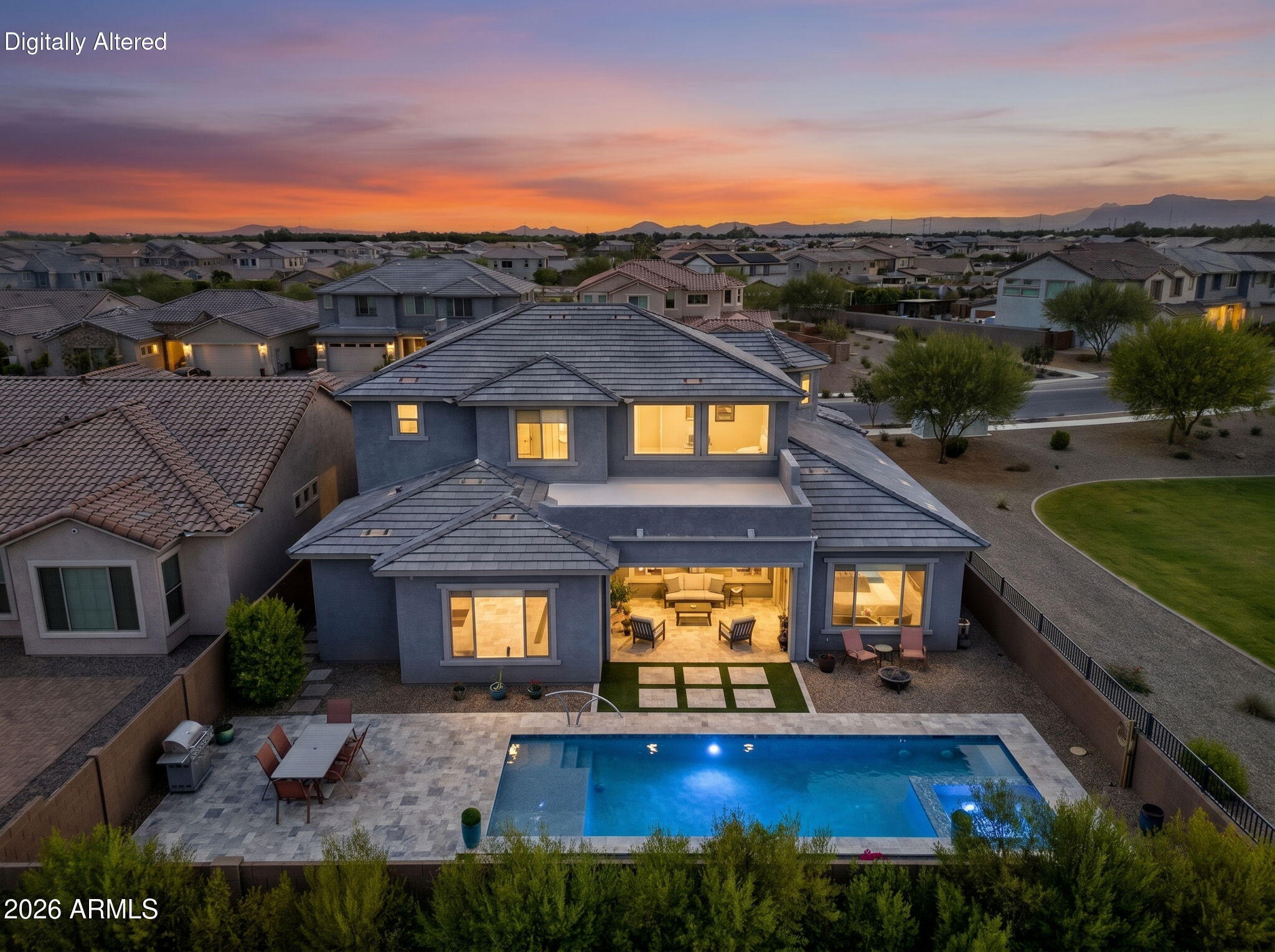 Experience grand living in this 6-bedroom home offering over 4,700 sq ft of thoughtfully designed space. A dramatic spiral staircase and soaring ceilings create a stunning first impression, while walls of windows fill the home with natural light. The private attached casita is accessed through the courtyard and features its own living area, kitchenette, bedroom, and bathroom, ideal for multigenerational living. Downstairs you'll find the primary suite plus an additional flex space offering possibilities for a game room, office, or additional living area. Upstairs offers 4 secondary bedrooms with walk-in closets, 2 bathrooms, and a spacious loft. Enjoy no neighbors to the east thanks to an adjacent greenspace, plus a backyard with a heated saltwater pool, spa, and easy-care landscaping.