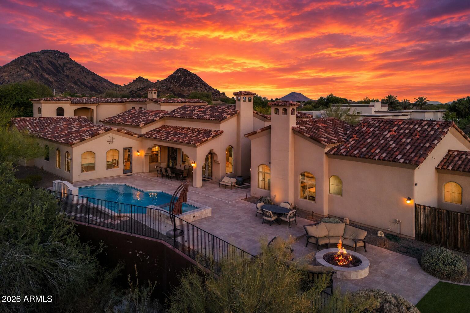 RARE CUSTOM ESTATE | ENTERTAINER'S BACKYARD | GUEST HOUSE | SPORT COURT | OVER AN ACRE

Privately tucked away on over an acre in Scottsdale, this custom estate blends timeless architecture with the kind of lifestyle amenities rarely found in one property. From the moment you arrive through the gated circular drive and porte-cochere entry, the home delivers a true sense of scale, privacy, and sophistication.

Designed for both entertaining and everyday living, the floor plan offers expansive gathering spaces, a private home theater, bonus/game room, office, and a split primary retreat downstairs. The chef's kitchen features granite counters, a large island, walk-in pantry, and seamless flow into the main living areas. The resort-style backyard was built to impress with a heated pool and spa, expansive outdoor entertaining spaces, a sport court, and breathtaking mountain and city light views. A detached guest house creates the ideal setup for multigenerational living, long-term guests, or a private workspace.

Additional highlights include a 4-car garage, RV gate and parking, smart home technology, vaulted ceilings, and North/South exposure adjacent to a wash for added privacy. A rare opportunity to own an estate property that perfectly balances luxury, functionality, and Arizona resort-style living.