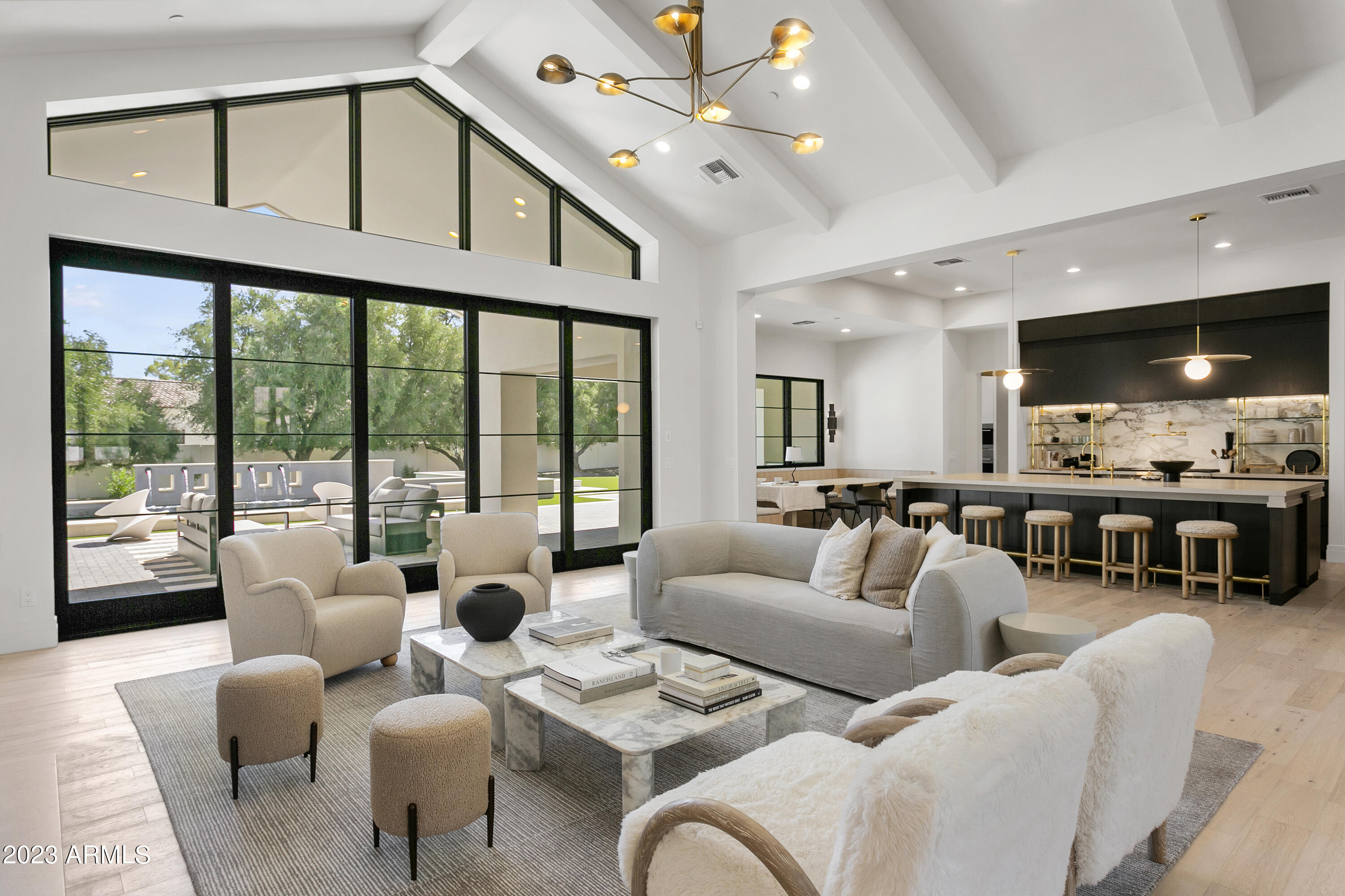 Exquisitely and meticulously designed and constructed by a top builder/designer team, this brand new custom home epitomizes luxury and elegance in Paradise Valley. All finishes, fixtures, features and technology are of the highest quality for the most discerning tastes.
The 6,537 SF main house with 1,136 SF attached casita is perfectly positioned on an acre plus lot in a fantastic neighborhood with prime mountain views. The sprawling lot features lush mature landscaping, low maintenance turf, sunken fire pit and heated pool complete with baja shelf, integrated zero edge spa and water/fire features. Enjoy indoor/outdoor Arizona living at its finest with the fully automated retractable door from the great room out to the endless patio space complete with outdoor kitchen area and multiple spots for lounging and dining. 
The main house features a split floor plan with junior master suite, two ensuite bedrooms, office and exercise room with shared bathroom (both with walk in closets and can be used as additional bedrooms). The huge bonus room makes for the perfect teen room, game room or movie theater. The amazing owner's suite includes a massive bedroom with intricate ceiling detail and a gorgeous bathroom straight out of a magazine with standing tub, steam shower, split vanities, his and her water closets and walk ins.
The jaw dropping chef's kitchen and stunning butler's pantry has all the finest Wolf/Subzero appliances and touches including wine fridge, wall oven, steam oven, cooling drawers, ice maker and much more. The kitchen includes a large breakfast nook with built in seating and opens up perfectly to the great room with its wall of glass, soaring ceiling height and fireplace. The dining room and entrance feature marble flooring, custom wine storage and wet bar. The beautiful laundry room includes another Subzero fridge, two sets of washer/dryers, endless storage and fantastic mountain views.
The attached casita overlooks the pool and is perfect for guests, studio, pool house, multi-generational living, etc. It includes a separate entrance, bedroom, bathroom, laundry room and a beautiful kitchen open to the family room. The oversized five car garage has room for all your cars and toys.