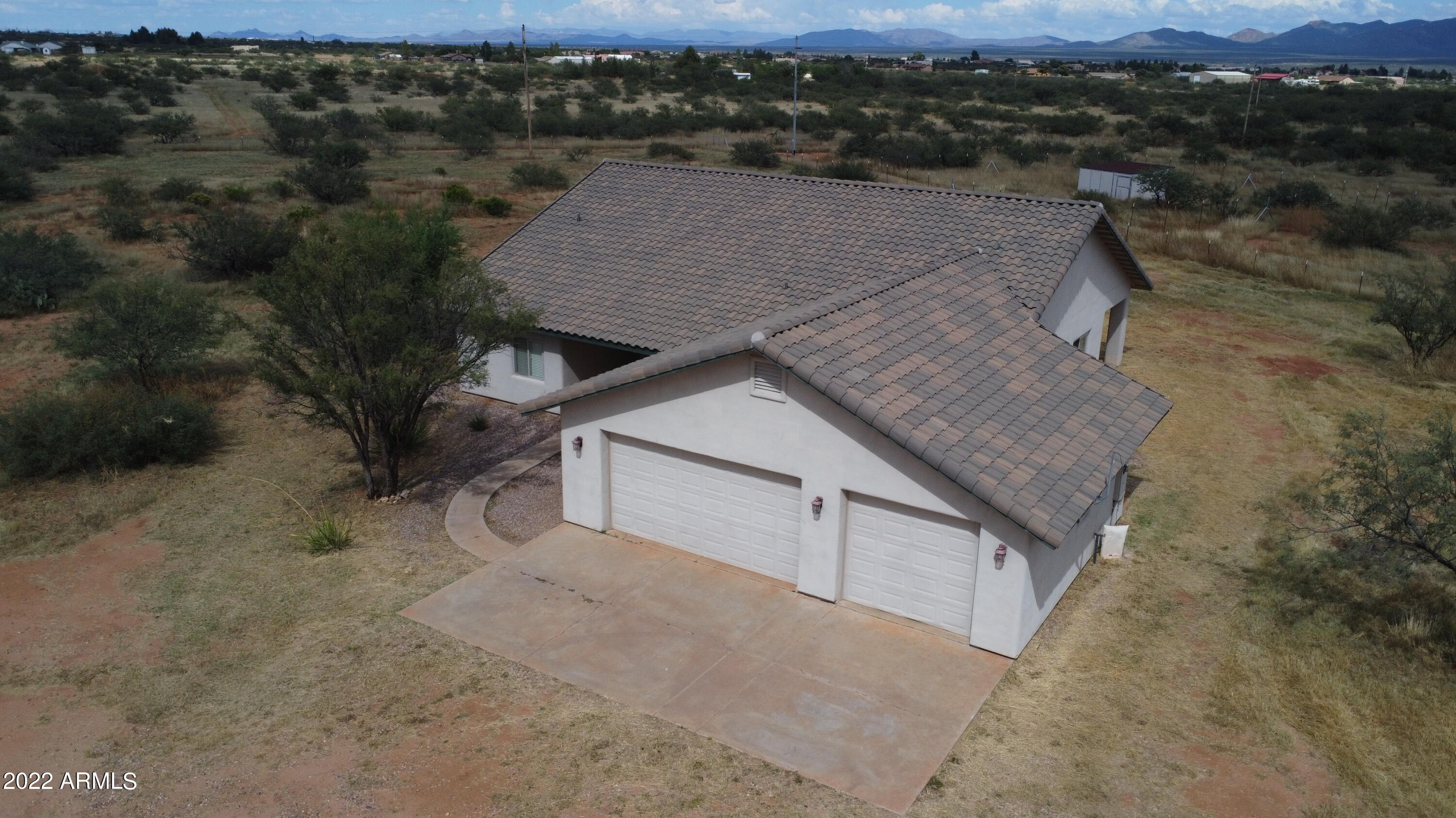 CUSTOM home with 360 degree Majestic Mountain Views!! All 8 acres are fenced and double fenced with an automatic ''mighty mule'' front gate. This 4BD/2BA home has custom tile throughout, a Great Room with an open, split floorplan and a roomy 3-car garage. The kitchen is a chef's delight with granite countertops, huge pantry, breakast bar and formal dining area. The beautiful master suite boasts two separate lighted mirrored closets, a custom tiled bathroom, executive height counters, double sinks and separate oversized garden tub and large tiled shower. There is also a laundry shoot from the master bath to the laundry room! Entertain on the back covered patio or enjoy the peace and tranquility with your morning brew. Make an appointment to view this amazing ''must see'' to appreciate home