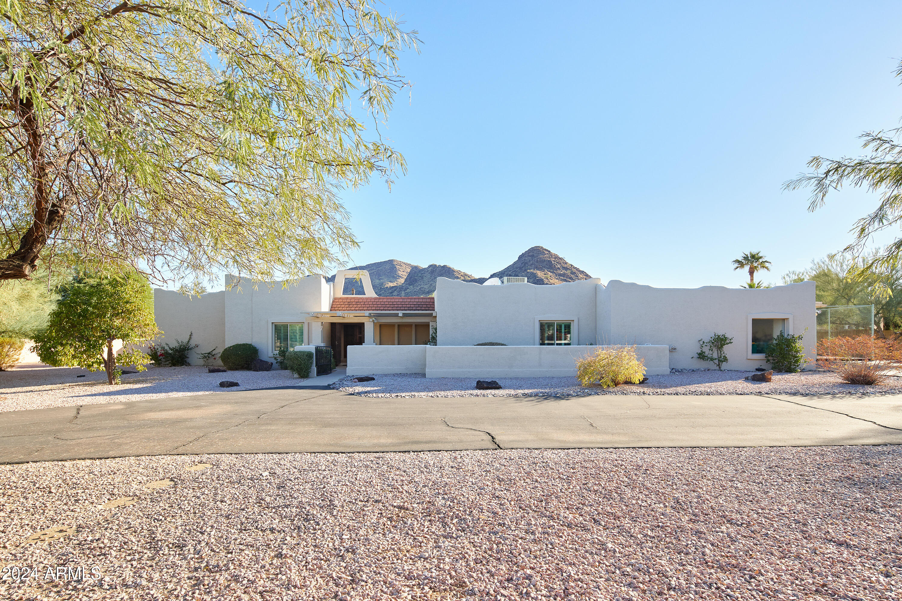 ATTENTION BUILDERS! PRIME OPPORUNITY. Over an acre in the desirable Mockingbird Lane Estates, this rare lot is nearly square, maximizing building envelope. Property includes full plans for a stunning 8,417sqf ultra modern mansion designed by legendary architect Stratton Architects costing around $400K and have already been approved for permit by the Town of Paradise Valley. Area has incredible comps, including the recent $32M sale just around the corner.