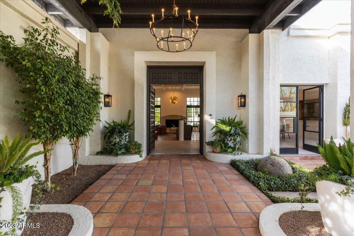 This modern family home designed by H.Ryan Studio has a Parisian feel that is timeless and chic. Located in Camelback Country Club Estates in Paradise Valley with 4700 square feet and includes 4 bedrooms and 5 bathrooms. Recently remodeled with an open floor plan, custom iron doors, and windows, a one-of-a-kind iron skylight over the large limestone island allows for lots of natural lighting. Beautiful wood flooring, European French Limestone tile, and a French Lacanche Stove with brass and polished nickel hardware, sub-zero refrigerator, 2 dishwashers, a microwave drawer, and much more are found in the custom kitchen. The parent lounge has a gas fireplace and a beautiful bar with a stone island, sub-zero wine refrigerator, ice maker, and dishwasher. Sitting on over 1 acre with lush mature landscaping, a sparkling pebble-tec pool with a water feature, a large covered patio with a gas grill, and European Limestone pavers. The master bedroom is large and has its own private patio.  The 3 bedrooms are spacious with en-suite bathrooms. This is a must-see to truly appreciate the detail that has gone into the design of this home.
