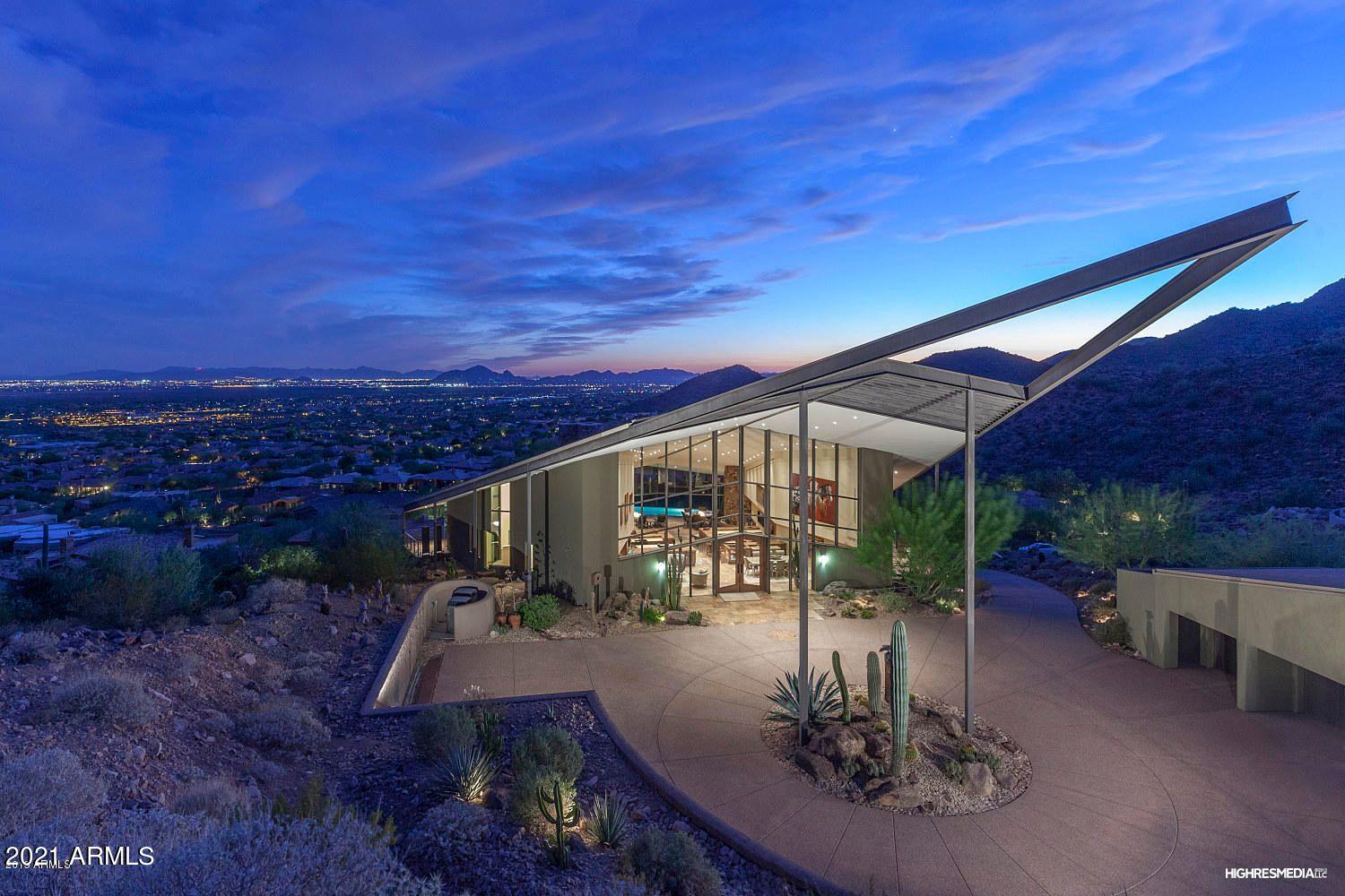 Private double gated two acre estate perched high above the valley! Walls of glass open up to sunsets, city lights, and mountain views. Welcome to your artfully minded retreat, The Diamond House. This one-of-a-kind masterpiece designed by world-famous AIA architect, Gordon Rogers, was built with design, privacy, and views in mind. Upon arrival in the motor court with a 5- car garage,  you will be wowed by the cantilevered steel entry. Head inside and prepare to have your breath taken away.  An impressive retractable glass wall seamlessly integrates to the infinity pool providing views to Camelback Mountain. Top of the line finishes throughout, including smart home technology, venting for artwork, solar, guest house & media system. Relax, entertain, and enjoy the finest of Scottsdale living Home Features:
* 2 large stone cylinder fireplaces with 6-fireplaces total
* Dacor appliances in kitchen
* Wetbar off kitchen w/ seating for 6
* Elevated city views and mountain views from rear
* Ground floor: Master + 2 guest bedrooms
* 2nd floor: 1 guest bedroom + Kitchen + Wet bar
* Top floor: dining and seating area
* Guest house with living room + guest suite
* Disappearing wall of glass door
