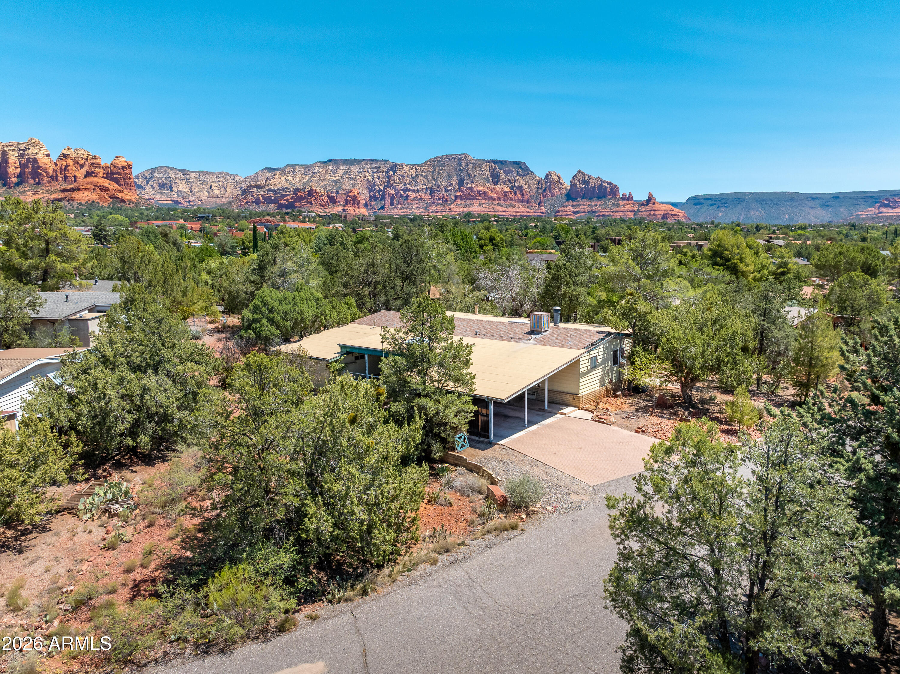 Opportunity meets location at 125 Camino Del Sol, offering an attainable entry into West Sedona homeownership without the restrictions of an HOA or age-limited community. Competitively priced at $390,000, this move-in ready 2-bedroom, 2-bath home offers the updates buyers wantalong with the opportunity to build equity over time.
Inside, you'll find an updated kitchen, refreshed bathrooms with tile showers,  upgraded flooring, plus the peace of mind of a newer roof and HVAC system. The enclosed sunroom perfectly frames views of Chimney Rock, while the backyard offers a quiet sitting area looking onto Coffee Pot Rock and Thunder Mountain. Two covered decks provide even more space to enjoy Sedona's beautiful weather. Located in the quiet Valley Shadows neighborhood, this home feels tucked away while still being less than half a mile from grocery stores, restaurants, and other everyday conveniences. With its central West Sedona location, thoughtful updates, and room to add your own personal touches with exterior improvements, this property offers an exceptional value in today's Sedona market.
