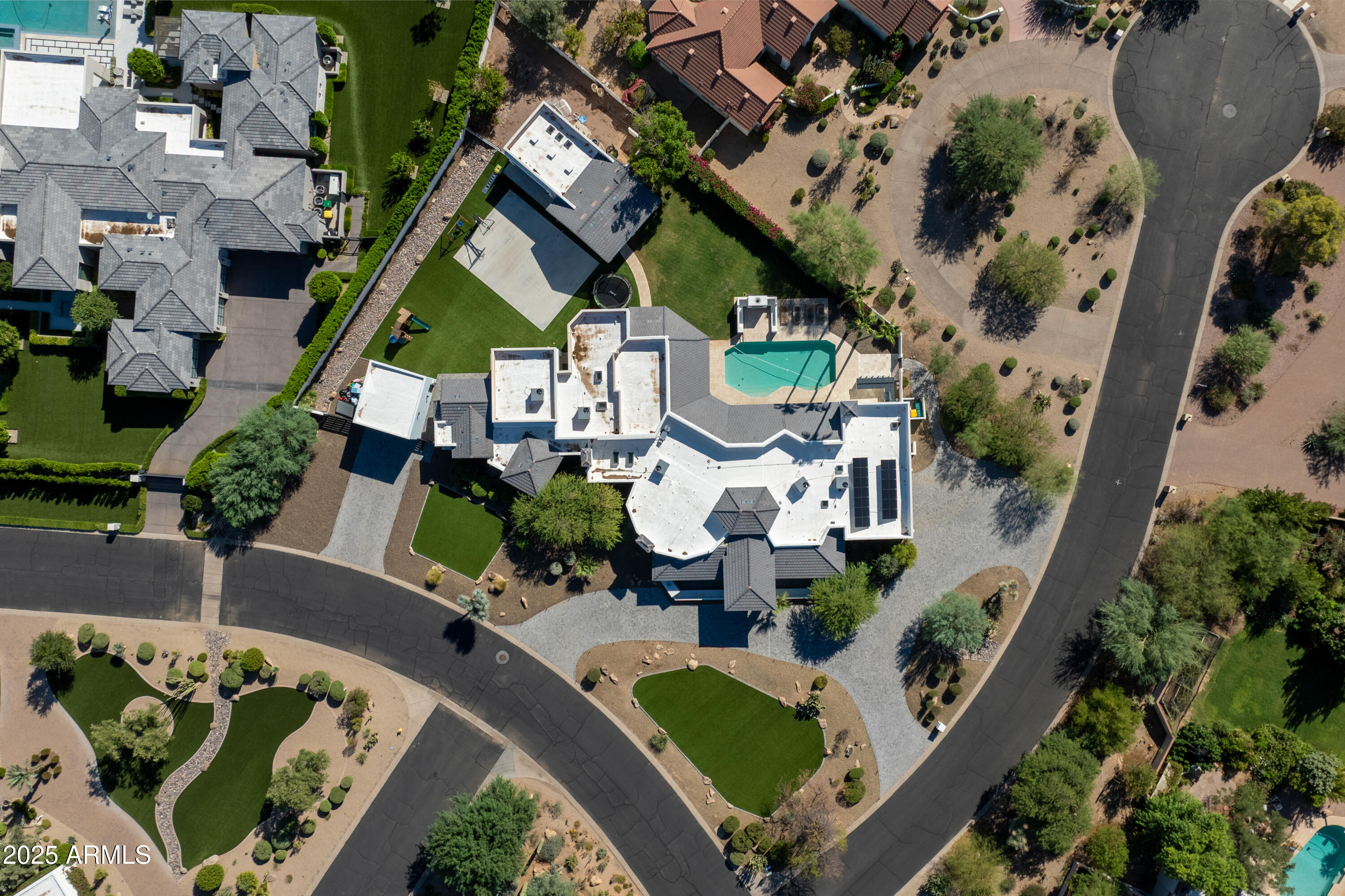 Situated in the heart of Paradise Valley, this exceptional estate is the result of a stunning 2-year, $2M rebuild and must be seen to be fully appreciated. Minutes from Fashion Square and surrounded by premier luxury estates, the expansive 6,300sf single level home offers 5 bedrooms, 5.5 baths, plus a den and teen room, along with a detached 570sf guest house. Interior highlights include white oak flooring t/o, soaring ceilings, incredible scale in every room, a wine cellar, smart lighting, pre-wiring for Crestron and Control4, and a chef's kitchen with Wolf and Sub-Zero appliances. Set on a full acre, the resort-style grounds feature a pool, covered patio, sport court, built-in BBQ,  lush lawns, owned solar, RV parking, and a 6-car garage—an extraordinary Paradise Valley offering.