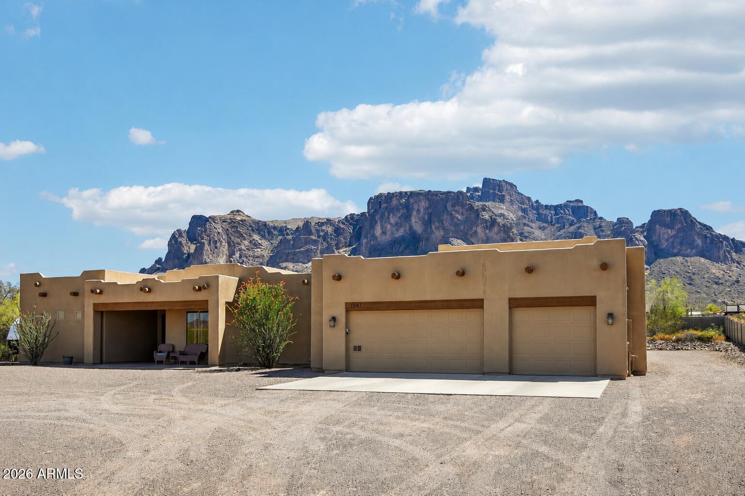 Experience true Arizona living at this beautifully maintained custom single-level home situated on 1.5 usable acres with stunning Superstition Mountains views. This spacious property offers over 2,300 sq ft with 3 bedrooms, 3 bathrooms, an office, and an oversized, extra-deep 3-car garage. The ~1,000 sq ft RV garage/workshop with over-height door provides outstanding space for RVs, toys, vehicles, storage, or hobbies. Step outside and enjoy the incredible outdoor living area featuring a covered ramada/gazebo with sink/bar area, fire pit, and mature desert landscaping highlighted by a spectacular saguaro cactus. Over $75k in recent improvements include perimeter block fencing, a mini-split system in the primary bedroom, new French doors, updated windows in two guest bedrooms and additional property enhancements. No HOA and horses are allowed, offering the freedom to fully enjoy the privacy, usable land, and unforgettable mountain views that make this property truly special.