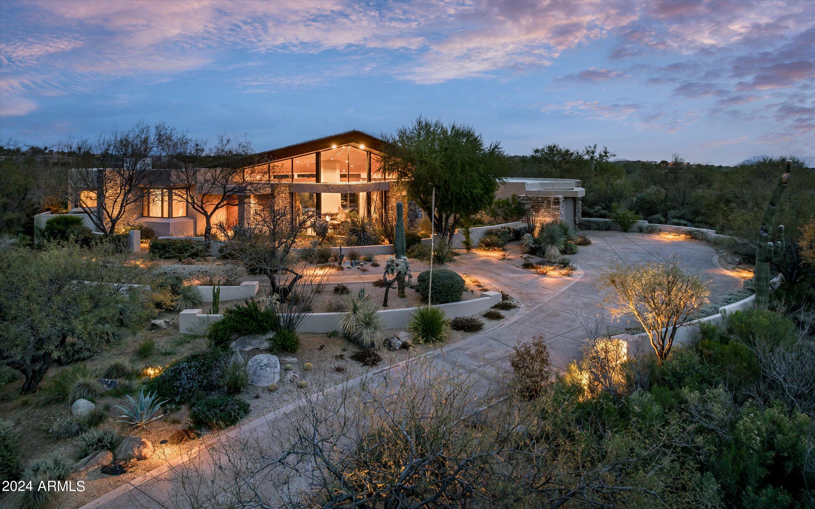 Social membership available for Buyer to purchase upon approval from the Desert Mountain Club. 
This charming gem nestled in village of Painted Sky offering spectacular mountain and golf course views is  centrally located within Desert Mountain.  A  prime location this property provides easy access to all golf courses, clubhouses, trails, fitness center, pickleball and tennis courts making it ideal for living on the mountain.  As you step inside you're greeted by a warm and inviting atmosphere. The soaring wood ceilings and walls of glass set the tone for the spacious great room area that features more than ample natural light creating a bright and airy ambiance perfect for relaxation or entertaining guests.  The open floor plan seamlessly connects the living space to the dining area and kitchen.  The guest wing features a living area with two with well-appointed bedrooms and baths each providing a peaceful retreat at the end of the day.  Additional bed and bath with bamboo floors allows maximum space for family and friends.  Enjoy working from the elevated office space all while enjoying the natural surrounds of the desert.  The owners suite is generous and private with two walk-in closets and bathroom that is sure to please offering a luxurious oasis for rest and rejuvenation.  Golf course views can be enjoyed from  the backyard also providing a serene escape with pool, private spa, multiple patio areas and BBQ/ bar.  Social membership available for Buyer to purchase upon approval from the Desert Mountain Club.