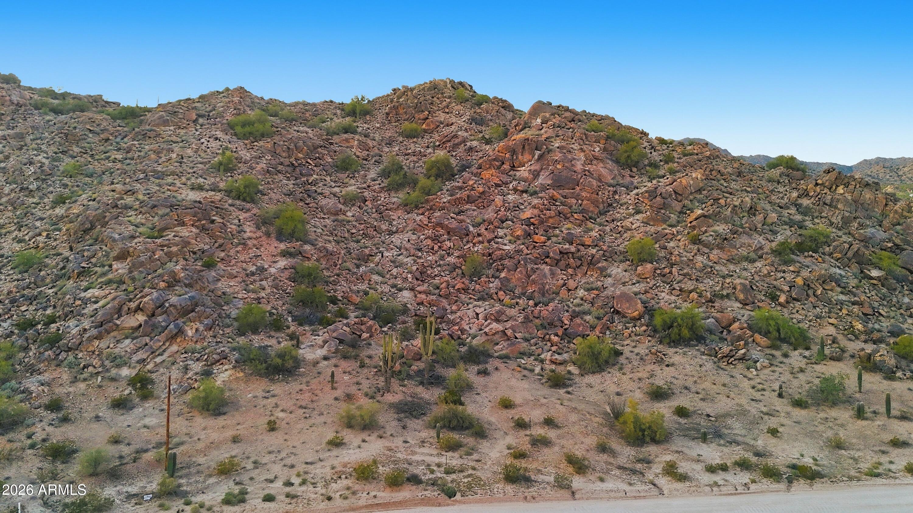 HIKE your OWN MOUNTAIN as high mountain rocks accent your BACK YARD.  GORGEOUS VIEWS  for MILES in this very PRIVATE area among MILLION DOLLAR  custom homes just a block from paved roads.  Great LOCATION within walking distance of NORTH MOUNTAIN PARK'S scenic trails, just five minutes from I-10, and 35 minutes to south Chandler. The building site on the south east corner AWAITS YOUR DREAM HOME.