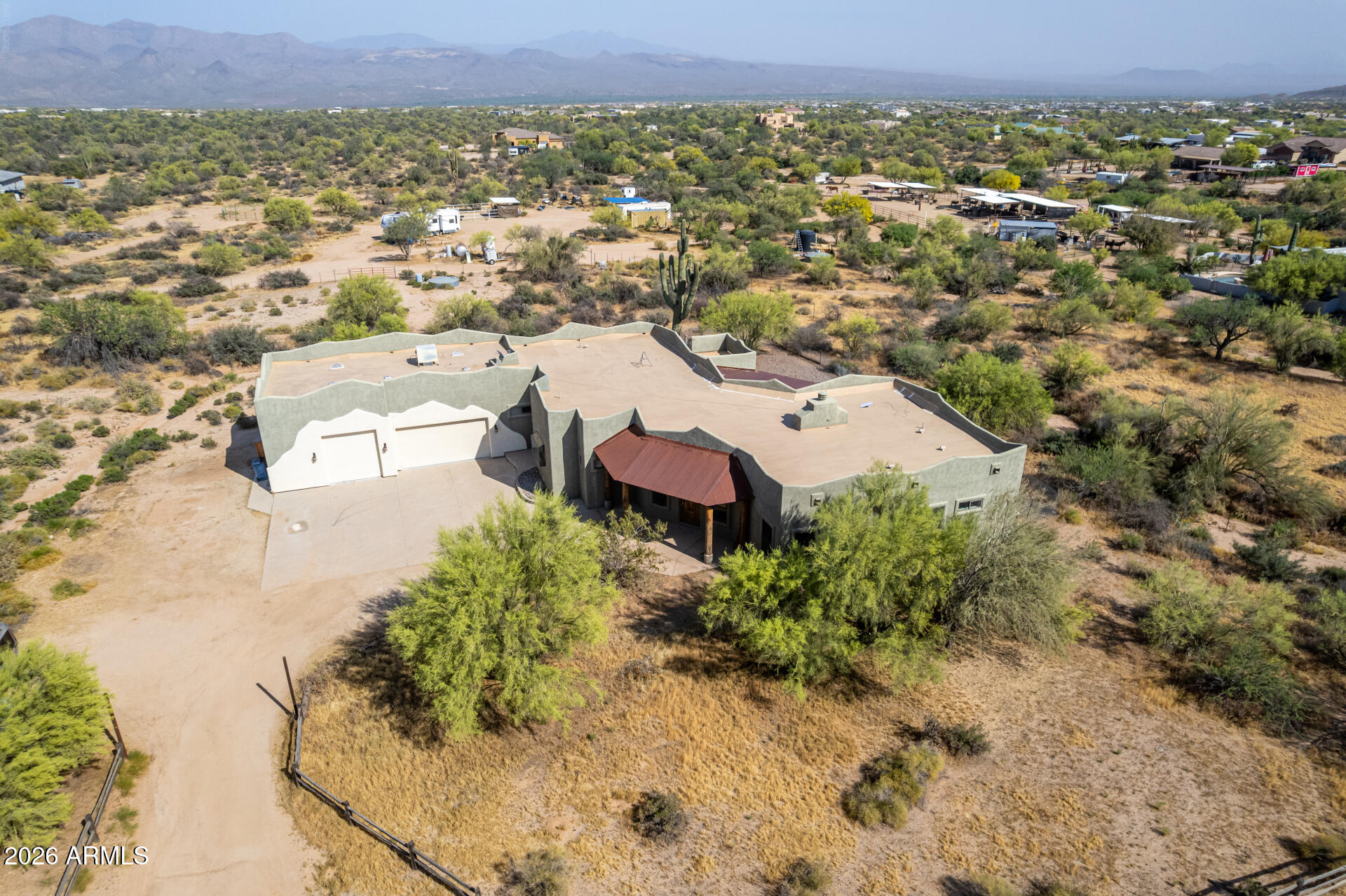 Fantastic opportunity to own this 4-bedroom home on a sprawling 2.5-acre horse property! You're welcomed by a 3-car garage, natural desert landscape, and an inviting front patio. Fall in love with the captivating living room with high ceilings, a soothing palette, recessed lighting, All new Saltillo tile flooring, interior paint, and a stone-clad fireplace. The stunning eat-in kitchen comes with granite counters, ample wood cabinetry, a stone-tile backsplash, stainless steel appliances, a pantry, and an island with a breakfast bar. The primary bedroom showcases sliding door access to the backyard for seamless indoor-outdoor flow, a private bathroom with dual sinks, and a walk-in closet. Unwind on the charming rooftop deck, offering panoramic views of the desert and distant mountains. The expansive outdoor space provides a sizeable covered patio, stylish pavers, and abundant space for crafting your dream outdoor oasis or establishing equestrian facilities. Don't miss out on this incredible gem!