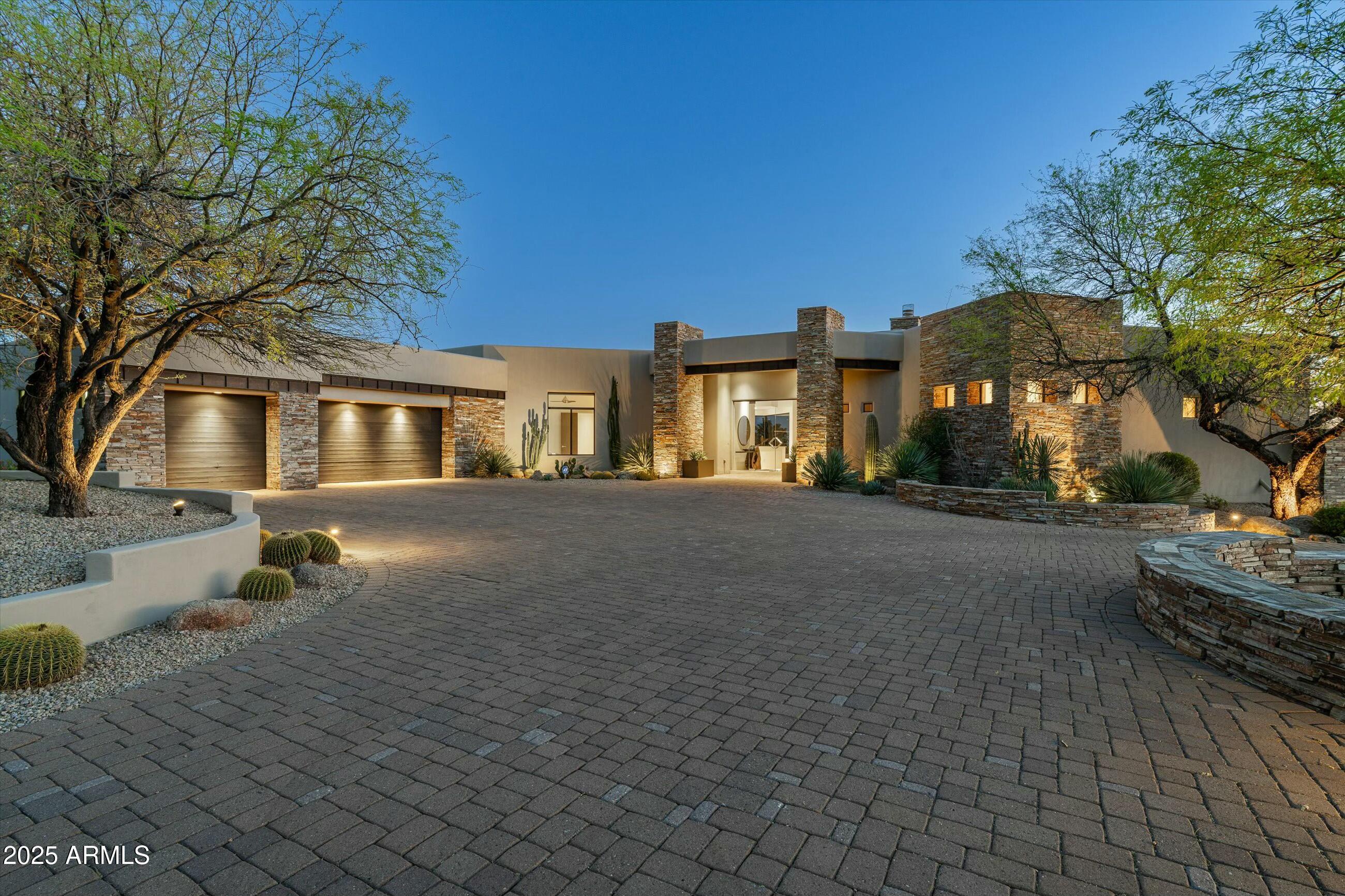 Golf membership available from seller. Stunning Desert Mountain retreat on the Apache golf course. Experience ultimate privacy and breathtaking beauty from this incredible home perched on the 15th hole of the Apache Golf Course — a scenic par 3 with lake views that make you feel like you're on your own island. This spacious, light-filled residence features 4 en-suite bedrooms, a powder room, and a layout designed for both relaxation and entertaining. The home has been thoughtfully planned with an open floor plan, walls of glass and abundant windows create a bright and inviting atmosphere throughout. Enjoy seamless indoor-outdoor living with multiple sliding doors leading to expansive patios. Large backyard features a pool, spa, fire feature, putting green and built in bbq