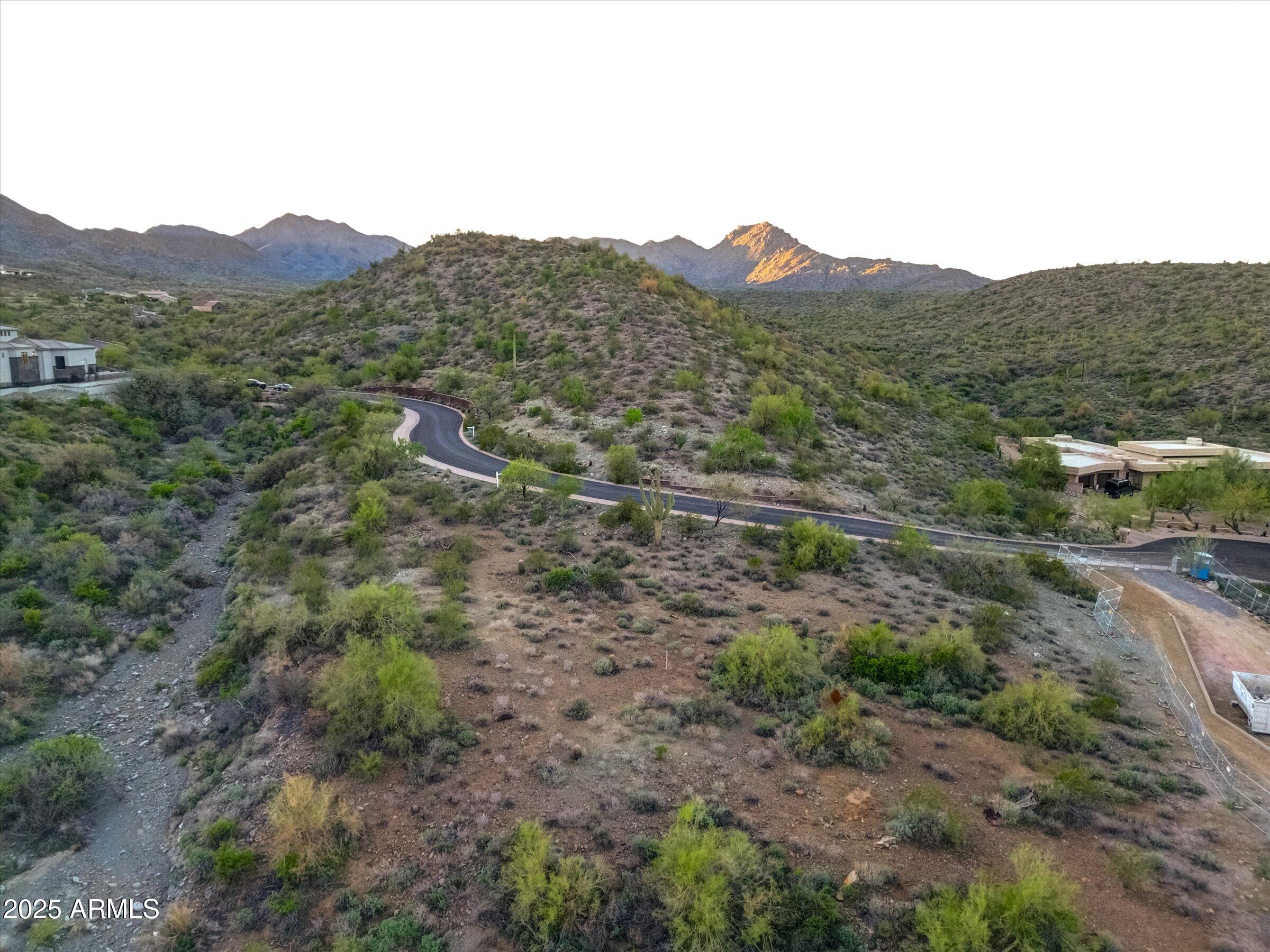 Capture extraordinary views and privacy when you build your dream home in the coveted Eagles Nest guard-gated community.  A hard-to-find acre lot with relatively flat building envelope of almost 14,000 sq ft awaits tucked in the serene foothills of Fountain Hills.  Take in the sunrise over the Four Peaks and silhouetted McDowell Mountain evenings.  Explore miles of trails when you hike or bike into the nearby preserves that border the community on 3 sides.  This location gives you the luxury living you've been searching for in a picturesque community while still being minutes to many of Fountain Hills' attractions and Scottsdale's shopping and restaurants.  The lifestyle in Eagle's Nest is for you if you enjoy peace, privacy, and natural desert beauty.