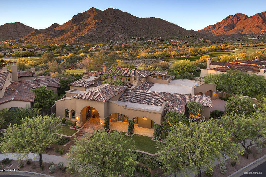 Silverleaf golf property!  Hard-to-find one level home on the golf course.  This nearly 6000 sf Spanish Mission residence sits proudly above Ethel's Garden park in the front and faces the 10th hole in back, allowing for unobstructed and dramatic mountain views. Fantastic floorplan features a master bedroom plus two guest suites, private office & media room in the main home; guest house and bonus room accessible from the central courtyard.  Stunning detailing found throughout, including reclaimed wide-plank oak and stone flooring, ceiling beamwork, custom cabinetry, top-end appliances &cappuccino maker, and decorative stone details in all bathrooms. The extremely private backyard is highlighted by a gracious pool and BBQ area, all taking in the wide expanse of the McDowell Mountains.