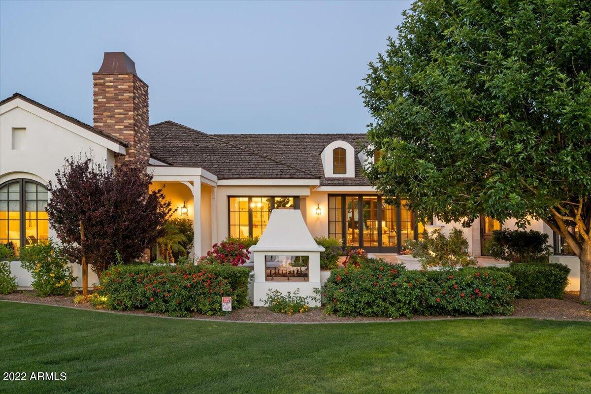 Classic French Country Home in the coveted, privately guard gated Casa Blanca Estates! This beautiful home was designed by the award-winning designer, Clay Scrivner and built by McNeely Signature Homes. Super private lot, as it's at the very end of the cul-de sac, with tons of room for guest parking.  As you approach the home, you will be greeted with 100-year-old Chicago brick courtyard, meandering gardens, soothing fountain, and mature trees. You'll truly appreciate the detail in the architecture as you approach the home. Light & bright Kitchen is open to the Great Room that has large wood-clad telescoping doors that disappear into the walls, Timber Truss spanning the room, and fireplace flanked with built-in bookcases. Hand-hewn Hickory floors are throughout the main living areas. Elegant details include over-sized marble island, custom cabinetry, Rohl and Waterstone plumbing fixtures, Sub-Zero Wolf appliances, spacious walk-in pantry and 2 dishwashers. Butler's pantry has Walnut countertop, warming drawer, built-in microwave & steam oven, along with a 700+bottle temperature-controlled wine room. Spacious Dining room has French doors leading to the tranquil courtyard and fireplace capturing incredible sunsets over Camelback Mtn.  Gorgeous Primary Suite has fireplace, charming window seat w/ Camelback Mtn views, enormous custom closet, and French doors leading to the courtyard. Spa-like Primary bathroom has Marble countertops, Marble floors, and jacuzzi soaking tub. 3 spacious En-suite Guest bedrooms have bathrooms with gorgeous tiles and walk in closets.  Flex/Game room off the kids wing, opens on to the backyard pool area. Opposite end of the home has an amazing library with Tongue & Groove ceilings, wet bar, charming fireplace, and French doors that open to a courtyard. Beyond the Library is a private office with pocket doors, gorgeous ceiling detail, rich millwork, and extraordinary views of Camelback Mtn. The backyard has synthetic lawn, plenty of room for a play area, lap pool, built in BBQ, mature grapefruit, lemon, and orange trees, and a pass thru bar with pocketed window. Technology includes whole house Sonos sound system, front and backyard speakers & sub-woofers, security cameras, and Rain Sensor control to outdoor landscaping.