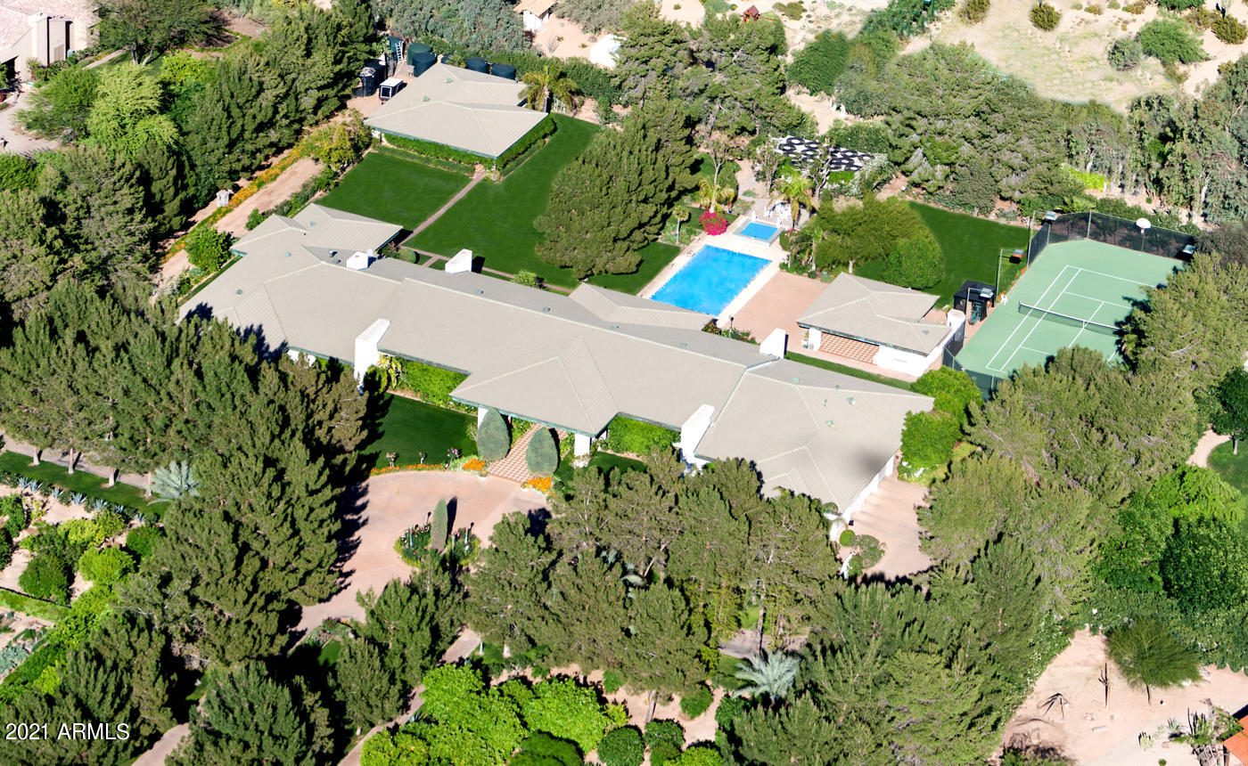 PREMIER PARADISE VALLEY LOCATION! 4.2 acre estate with 2 wells includes two lots APN 174-62-005F and174-62-005G. Live in 1,400sf recently remodeled (2021) guest house while remodeling existing 8000 sf home with 6 garages or build your dream home. Firewood does not convey.