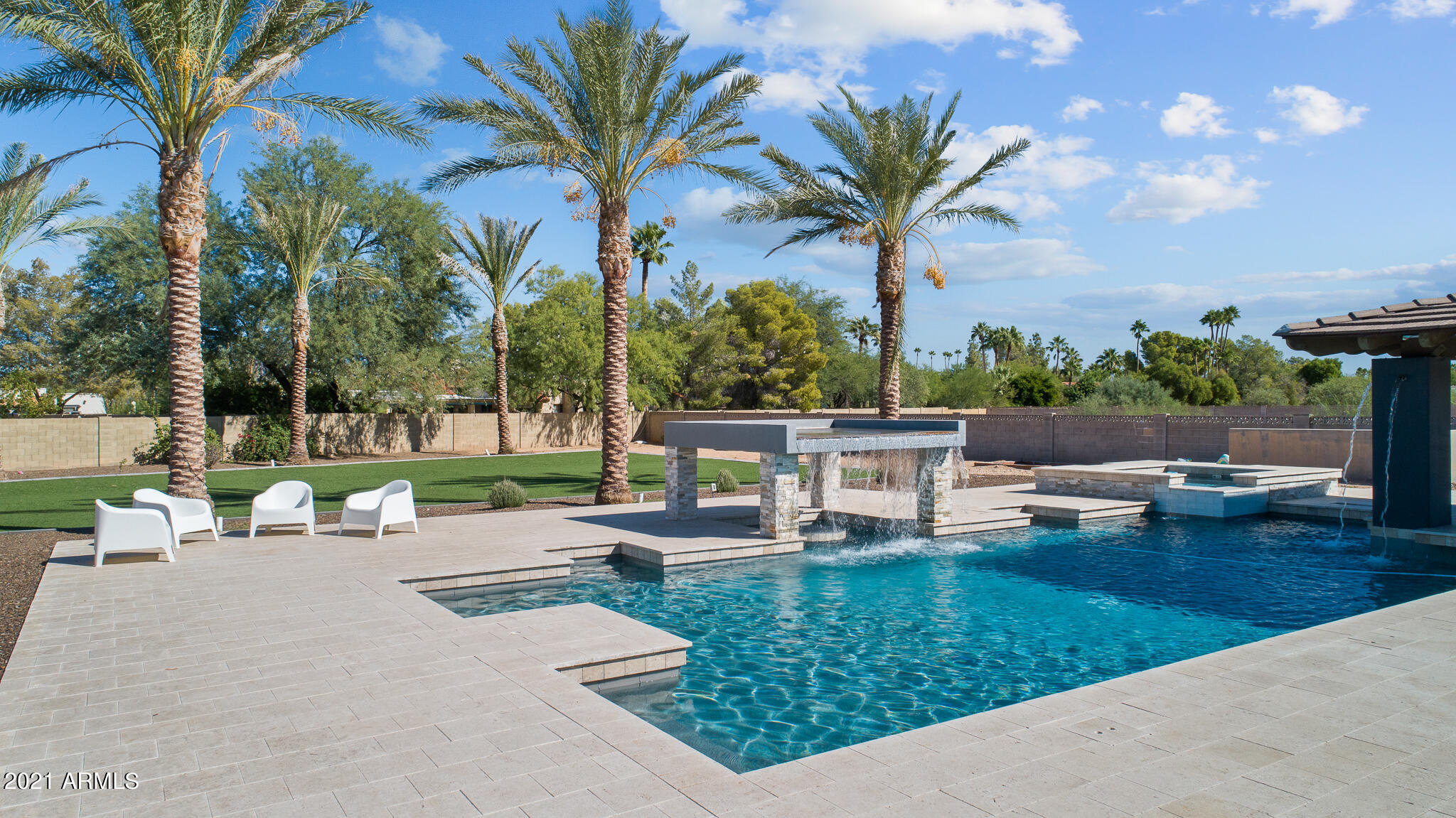 Entertainers paradise in Scottsdale! This MASSIVE 4 bedroom, 4.5 bathroom home is complete with modern tile flooring, vaulted ceilings, and plenty of natural light throughout. The open-concept living area with retractable doors allows you to enjoy a fall breeze while spending time with guests or binging your favorite Netflix series in the family room. Prepare meals like a culinary expert in this gourmet, chef inspired kitchen complete with quartz & granite countertops, stainless steel appliances, 48'' wolf range, multiple ovens, and a huge breakfast area! Mix up a few cocktails in the indoor wet bar area with ice machine before enjoying a game of pool. The bright, airy Owner's Suite and ensuite equipped with a walk-in shower, luxurious soaking tub, sizeable walk-in closet, and exercise room with a sauna is the perfect sanctuary to retreat to after a long day. Love entertaining guests? Then this is the backyard for you! Spend your days splashing around in the inground pool, relaxing in the spa, or reading a book under the covered patio. The professional bocce ball court, batting cage, putting green, and 6,000 sqft of turf and artificial grass are sure to make your home the go to spot amongst your friends for game nights or backyard BBQ's. Plans and permits have also been completed for a 2,040 sqft casita that is just waiting to be built. The best backyard feature of all is the AMAZING 30 year old tortoise, Sophie, that calls the large tree in the back of the yard home. You'll love living right in the heart of Scottsdale with Rt 101, dining, and entertainment options like McCormick Ranch Golf Club, Great Wolf Lodge, KTR Indoor Sports Playground, Spring Training locations, and Mavrix right around the corner. The lack of HOA and quick access to everything Scottsdale has to offer makes this home an ideal opportunity for a luxury Airbnb. Hurry in today to get your hands on this truly one-of-a-kind Scottsdale home!