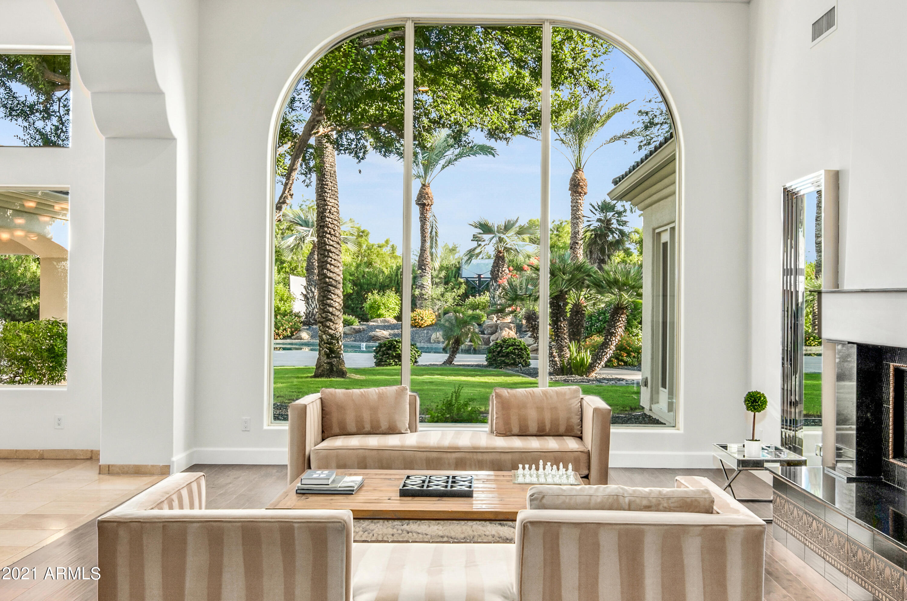 ONE OF THE MOST STUNNING AND WELCOMING HOMES TO BE OFFERED IN PARADISE VALLEY OR SCOTTSDALE IN MONTHS. A true 'Rare Find'. Enter this beautiful home to be awed by soaring 20 foot ceilings, looking onto one of the most beautiful backyards in Paradise Valley. Sitting privately on well OVER an acre w/SPORTS COURT/ putting green and more!  Including, if being in PV's PREMIER location is important to you...then this home will capture your heart; as will, the brand new concrete tile roof installed Aug - New Paint, fixtures, upgraded baths, new quartz counters. Take comfort in this while you enjoy your huge master suite with spacious sitting room, a GUEST suite, workout room, a separate executive office, all bedrooms w/en-suite baths, 3 Trane Air conditioners and gated entry and VIEWS! SEE MO North /South Orientation ! Comparable size and location remodeled homes are currently selling for over 5 million in Paradise Valley.. SELLER has just had all cabinets painted and new counter tops installed when Floors are also installed price will be 4.1