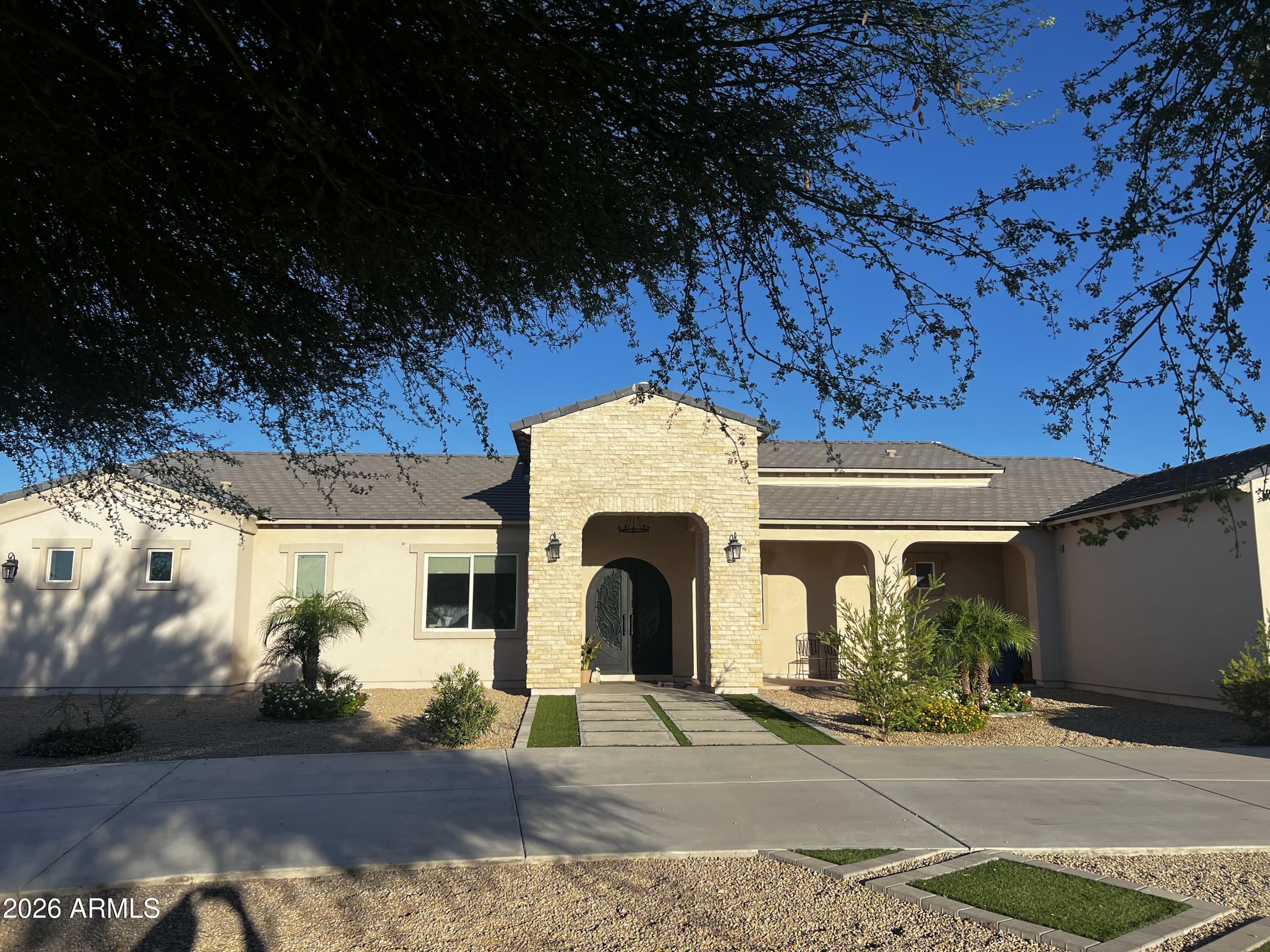 Exceptional custom-built estate with no HOA, built in 2019, situated on approximately 1.25 acres. The main residence offers 3,328 sq ft of thoughtfully designed living space featuring 4 bedrooms, 3.5 bathrooms, and a versatile flex room ideal for a home office, den, or playroom. High ceilings, abundant natural light, and quality finishes create an inviting atmosphere throughout. The chef's kitchen features granite countertops, stainless steel appliances, abundant cabinetry, a spacious pantry, and generous workspace, making it ideal for everyday living and entertaining. The primary suite offers an elegant retreat with oversized closets and a spa-inspired bath. The detached casita offers approximately 1,053 sq ft and includes 1 bedroom, 1 bathroom, a kitchenette, and its own 2-car garage, providing exceptional flexibility for guests, multigenerational living, extended family, or a private workspace.
Step outside to your private backyard oasis featuring a sparkling swimming pool, an extended covered patio, mountain views, and plenty of space to relax or entertain. The property also offers RV parking, an RV gate, horse privileges, and endless possibilities for outdoor living. An attached 3-car garage complements the main residence. Enjoy the privacy of country-style living while remaining just minutes from shopping, dining, and everyday conveniences.