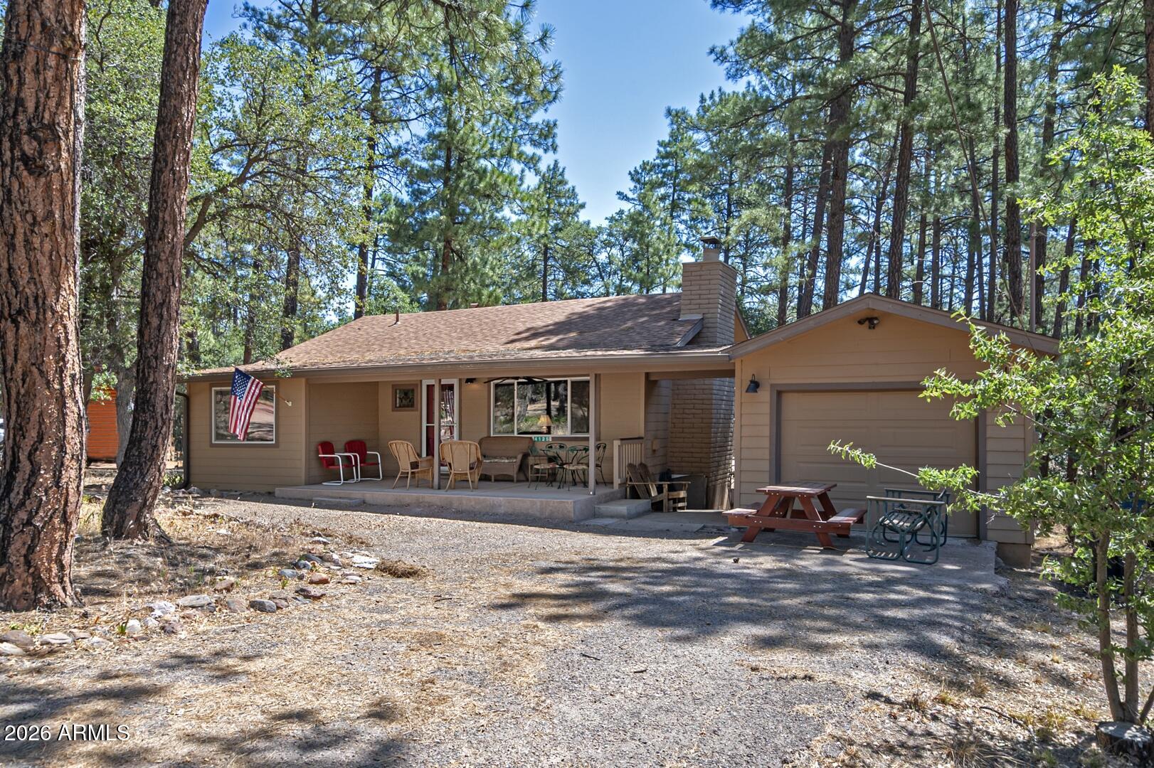 Charming single-level cabin nestled in the woods, beautifully remodeled and move-in ready! This inviting woodland retreat features newer siding, roof, windows, hickory laminate flooring, updated kitchen cabinets, and completely remodeled bathrooms. The open, comfortable floor plan is highlighted by a wonderful wood-burning fireplace, creating the perfect cozy mountain atmosphere. Enjoy year-round comfort with forced-air heating and central air conditioning. A single-car garage provides added convenience and storage. Whether you're looking for a full-time residence, weekend getaway, or vacation home, this beautifully updated cabin offers the perfect blend of modern amenities and peaceful mountain living.
