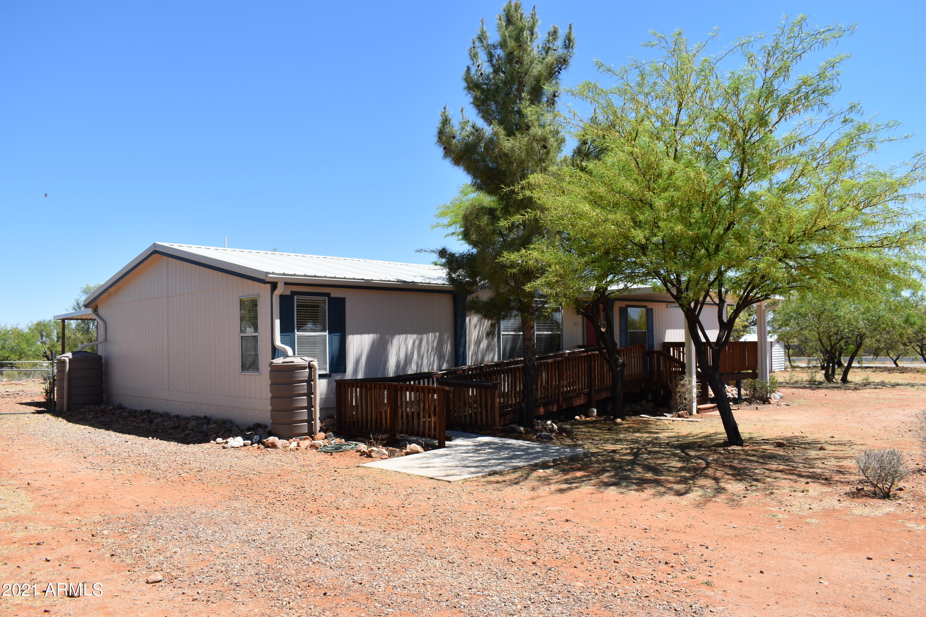 Welcome HOME! This 4 bedroom 2 bath home is situated on half an acre with beautiful mountain views from your large covered front patio. Inside you will find 2 large living rooms, new flooring in all the right places, an updated kitchen and guest shower.  A new metal roof was installed in the last few years a long with a large back patio and rain water collectors for the avid gardener. Don't miss out on this wonderful home! Virtual Tour provided.