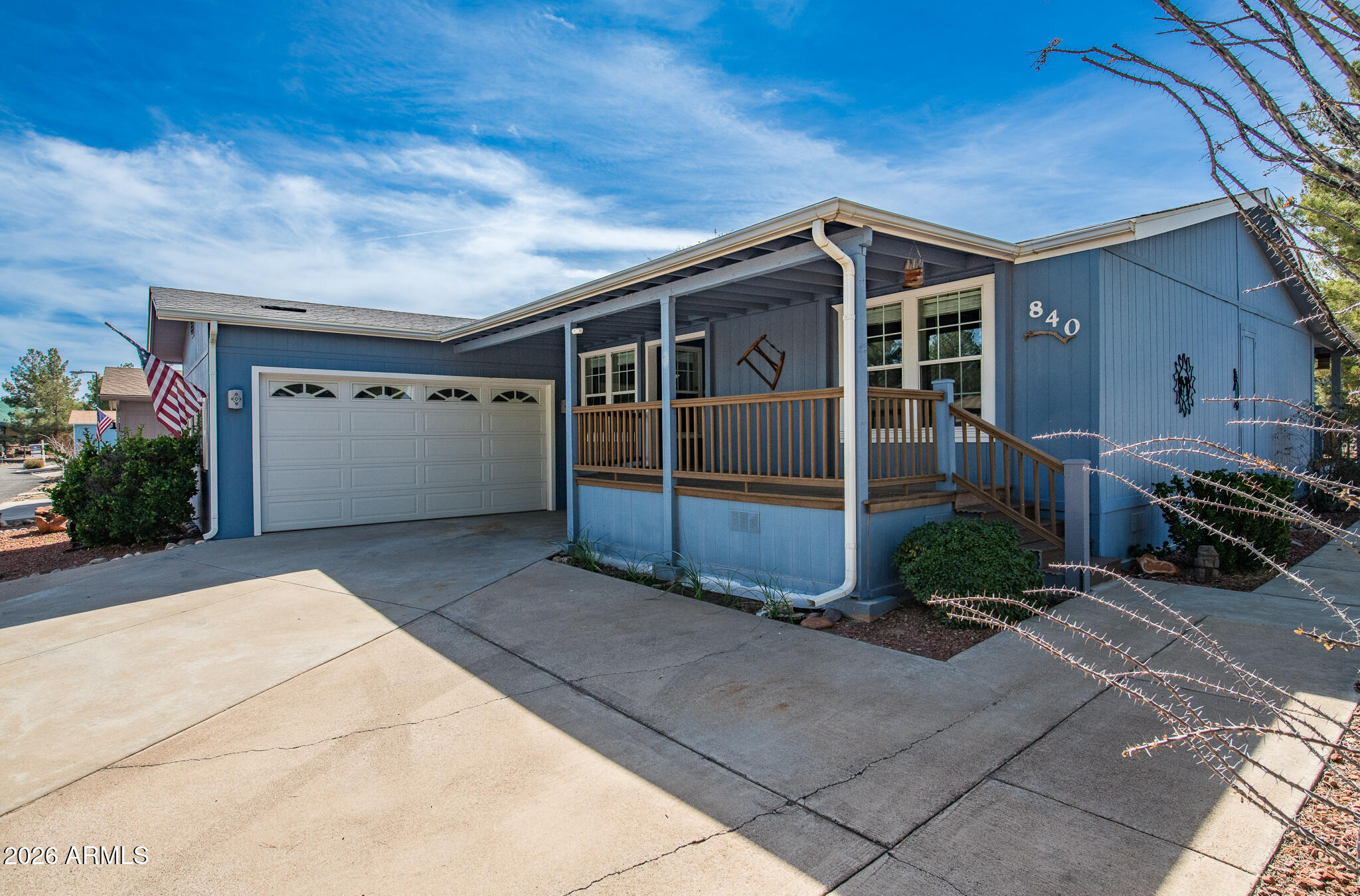 Welcome to this well-maintained 2006 Cavco home offering 1,632 sq ft of comfortable living space and an open-concept floor plan. The home features 2 bedrooms plus an office and a desirable split-bedroom layout for added privacy. Newer laminate wood flooring runs through the main living room and bedrooms creating a warm and inviting feel. The kitchen includes a new stainless steel oven and microwave, ready for everyday cooking and entertaining. Enjoy outdoor living with large covered front and back porches, perfect for relaxing or gathering with guests. The property also features a spacious two-car garage and an extended driveway providing ample parking and convenience. A great combination of space, functionality. 55+ community, Lot Lease $583.67 mo. Community approval required for buyer.