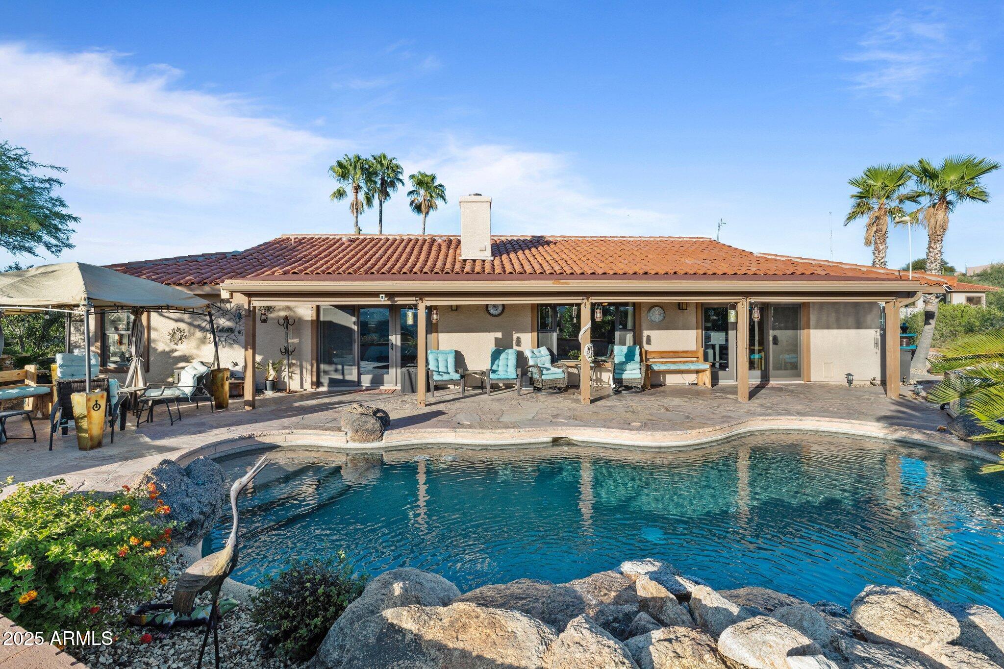 Discover this Exceptional 3-Bedroom, 2-Bathroom Home Offering 2,000 SF of Comfortable Living Space in Prestigious Rio Vista Hills. The 
Residence Also Includes a Dedicated Office. Property  Features a Remarkable  Detached Guest Quarters perfect for Additional Overnight Space. Automotive Enthusiasts will appreciate the 2-Car Attached  Garage PLUS an Impressive 3-car Detached Garage and Workshop 
Space OR Another Stall. Property Showcases Meticulous Landscaping Maintained to 
Perfection, Creating an Oasis with Refreshing Heated Saltwater Pool with
 Breathtaking 360-degree Views. Additional amenities include Convenient Storage Shed and Secure Gated Entry. Located near Hassayampa River Preserve. This Rare Offering Combines Rural 
Tranquility with Modern Conveniences.