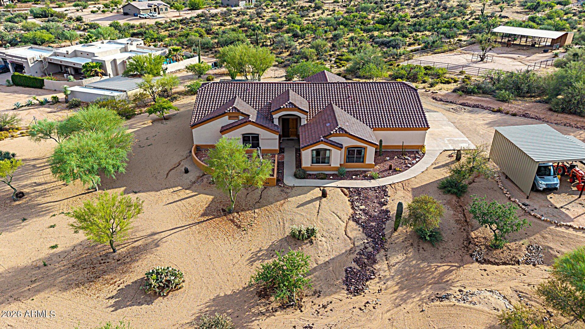 Escape to the serenity of country living w/ this exceptional custom hm, set on 2.5 acres w/horse privileges, a private well, & no HOA! Designed for both comfort and functionality, this inviting home features expansive living spaces enhanced by soaring vaulted ceilings and skylights that bathe the interior in natural light. The beautifully appointed kitchen offers abundant cabinetry, granite countertops, a spacious walk-in pantry, and essential appliances, creating the perfect space for everyday living and entertaining. The generous primary suite provides a peaceful retreat w/ a walk-in closet and a spa-inspired ensuite featuring dual vanities, a soaking tub, and a separate shower. Property located steps away from the Scottsdale Preserve & Tonto National Forest for off-road adventures... Step outside to enjoy the covered patio capturing breathtaking mountain views, and overlooking the expansive backyard, offering endless possibilities for horse facilities, guest casita, RV garage/shop, pool, gardening, or simply relaxing under Arizona skies.  The oversized 5th bedroom could make a spacious home office or hobby/game room. Completing this outstanding property are a 4-car garage, and additional covered parking, for cars, tractors, equipment, etc. Free and clear $35,000+ solar system, for low cost utility bills, (average $35/mo.), and a private well, delivering both convenience and long-term value. This rare opportunity combines space, privacy, and versatility in one remarkable property. Low property taxes. Don't miss your chance to make it yours!