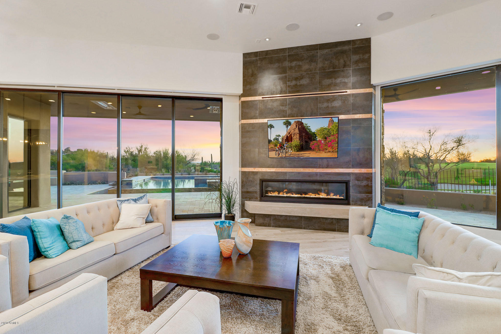 Welcome to Boulder Point, luxury living in the Reserve at the Boulders. This one of  kind, custom soft contemporary home is positioned on two golf holes including the 18th home hole and features stunning 270 degree views of the mountains.  An entertainers dream home and the only newly constructed home in the Valley on two golf holes!  The home itself features a master wing split from the other 2 bedrooms in the main house. Professionally designed the home features Quartz counters, real wood flooring, custom lighting, incredible cabinet package and top of the line Sub Zero and Wolf appliances. Tons of glass and golf course views from EVERY single bed/living room. 3 car oversized air conditioned garage with car charging port can be expanded to 4 car capability with pre designed lift. (MORE) Casita features and additional separate garage for guests with a fully functional kitchenette, bath and W/D.  This "smart home" features full Control 4 wiring and integration (not just pre wired) . Lutron lighting, HVAC, pool, electronic shades , surround sound, fireplaces, ceiling fans etc all fully integrated and ready to use immediately upon move in. The backyard is an entertainer's dream with breathtaking views in every direction, reverse infinity edge pool, built in gas BBQ, fire pit, misting system with built in heaters.  
Extensive video and Matterport walk throughs available for you to see from your computer - contact agent today!