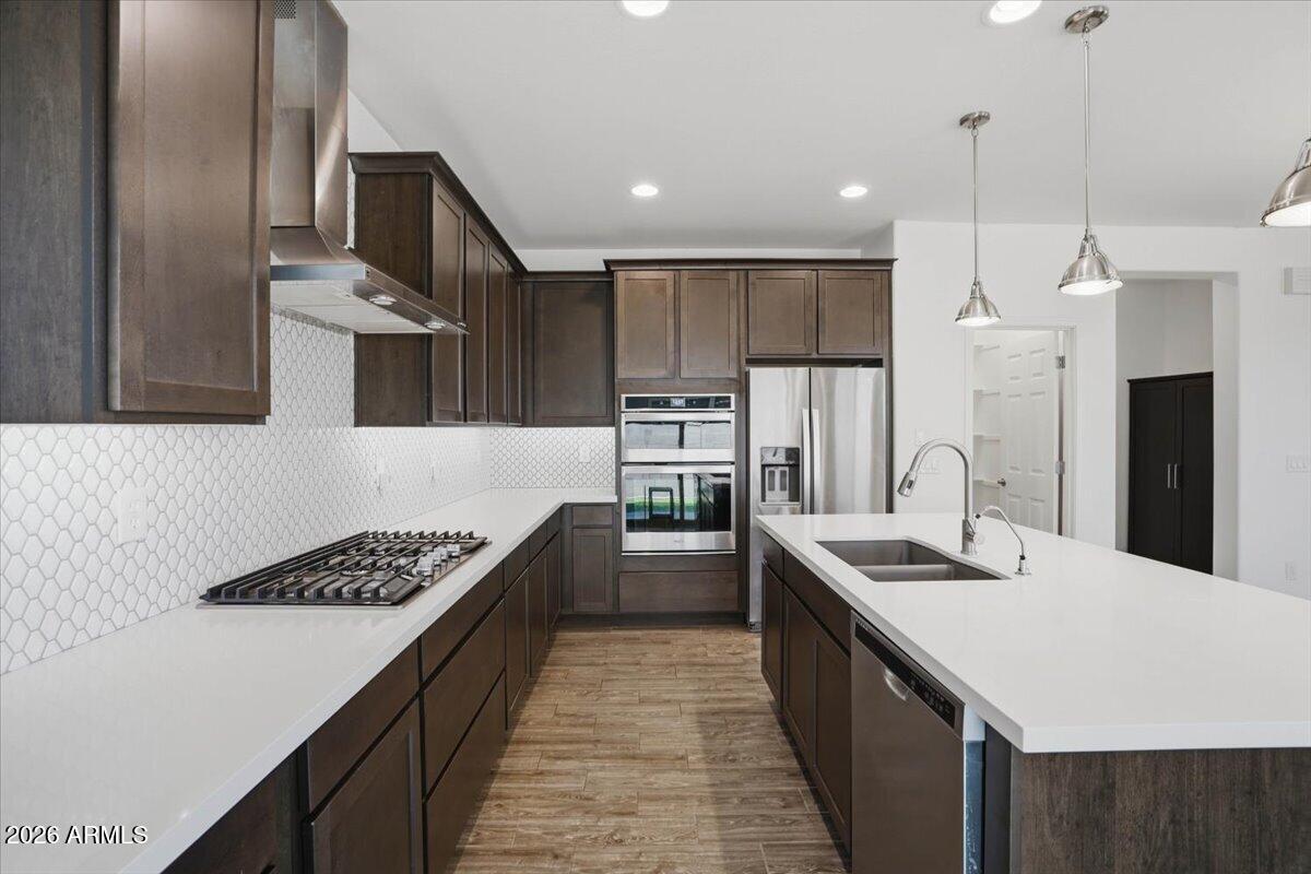 Welcome to this beautifully upgraded two-story home located in the highly sought-after Eastmark community in Mesa! Offering 4 bedrooms, 3 bathrooms, and over 2,500 square feet of thoughtfully designed living space, this home combines modern style, functionality, and an incredible location directly across from a park.

Inside, you'll find spacious living areas filled with natural light, modern finishes, and over $70,000 in upgrades throughout. The stunning upgraded kitchen is the heart of the home, featuring stylish finishes, ample cabinetry, generous counter space, and an open layout perfect for both everyday living and entertaining.

The floor plan is ideal for multi-generational living or guests with a downstairs bedroom and full bathroom that can easily function as a private ensuite Throughout the home, you'll appreciate the clean and modern feel with flooring everywhere except the bedrooms, where carpet adds warmth and comfort. The home also offers convenient side door access to the garage for added functionality and ease.

Step outside to your beautifully designed backyard built for low-maintenance Arizona living. Complete with upgraded pavers, artificial turf, a built-in BBQ, and a gas fire pit all connected directly to the main gas line, this outdoor space is perfect for entertaining, relaxing evenings, and enjoying time with family and friends year-round.

Located in the award-winning Eastmark master-planned community, residents enjoy access to parks, walking paths, playgrounds, splash pads, community events, and some of the best amenities the East Valley has to offer -- including a popular 18-hole disc golf course. In this specific neighborhood, the HOA also maintains the front yard landscaping, creating easy, low-maintenance living and great curb appeal year-round.

With its unbeatable combination of luxury upgrades, functional layout, and prime location, this is a home you won't want to miss.