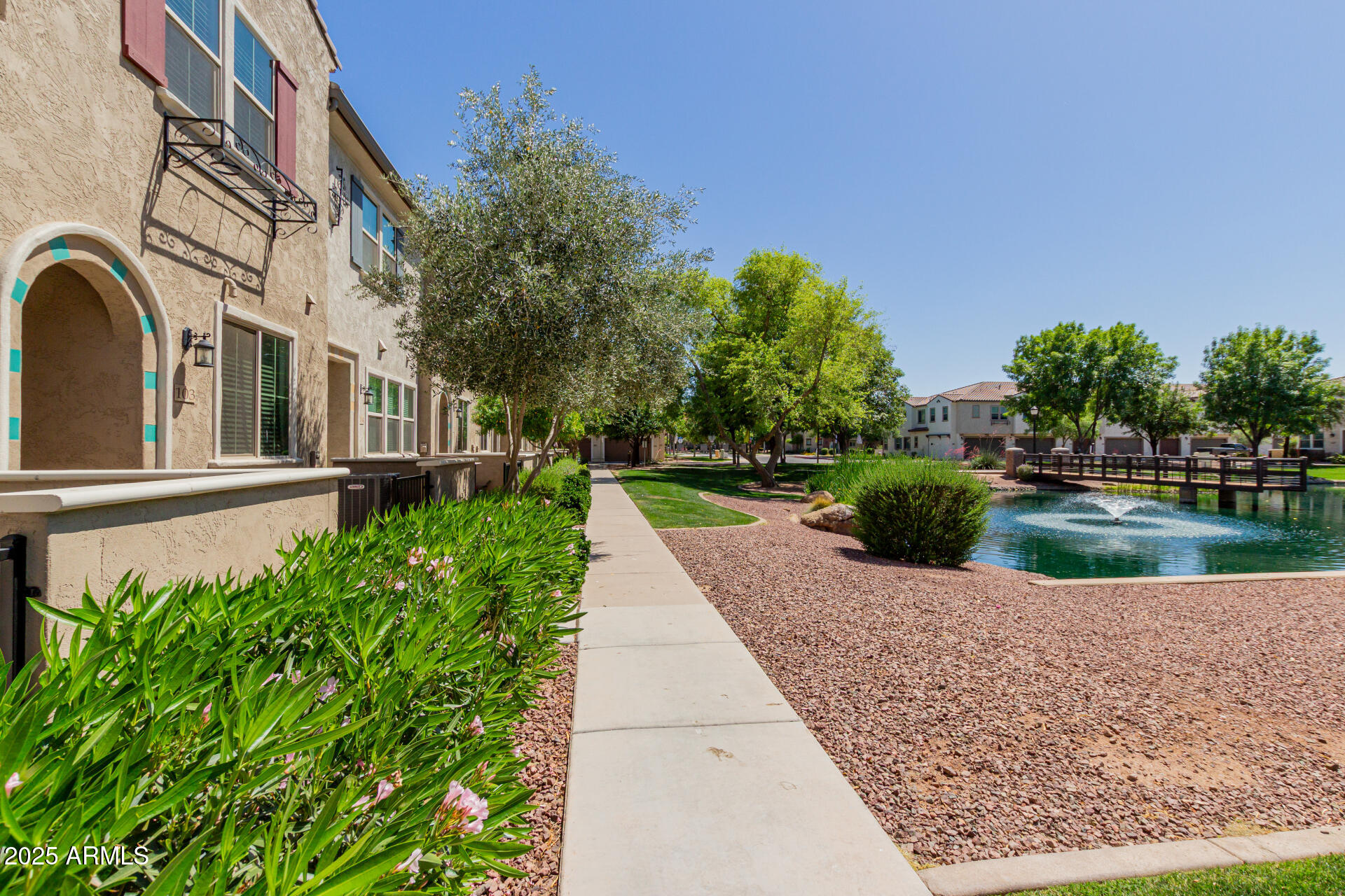 Don't miss this rare opportunity to own one of the best-located homes in the neighborhood! Perfectly positioned with lake views and just steps from the community pool. Features include a tandem two-car garage with extra parking nearby, elegant tile flooring, quartz countertops, stainless steel appliances, and rich espresso cabinets. The primary suite offers a spacious walk-in closet and sleek walk-in shower. Close to San Tan Village's premier shopping, dining, and entertainment.