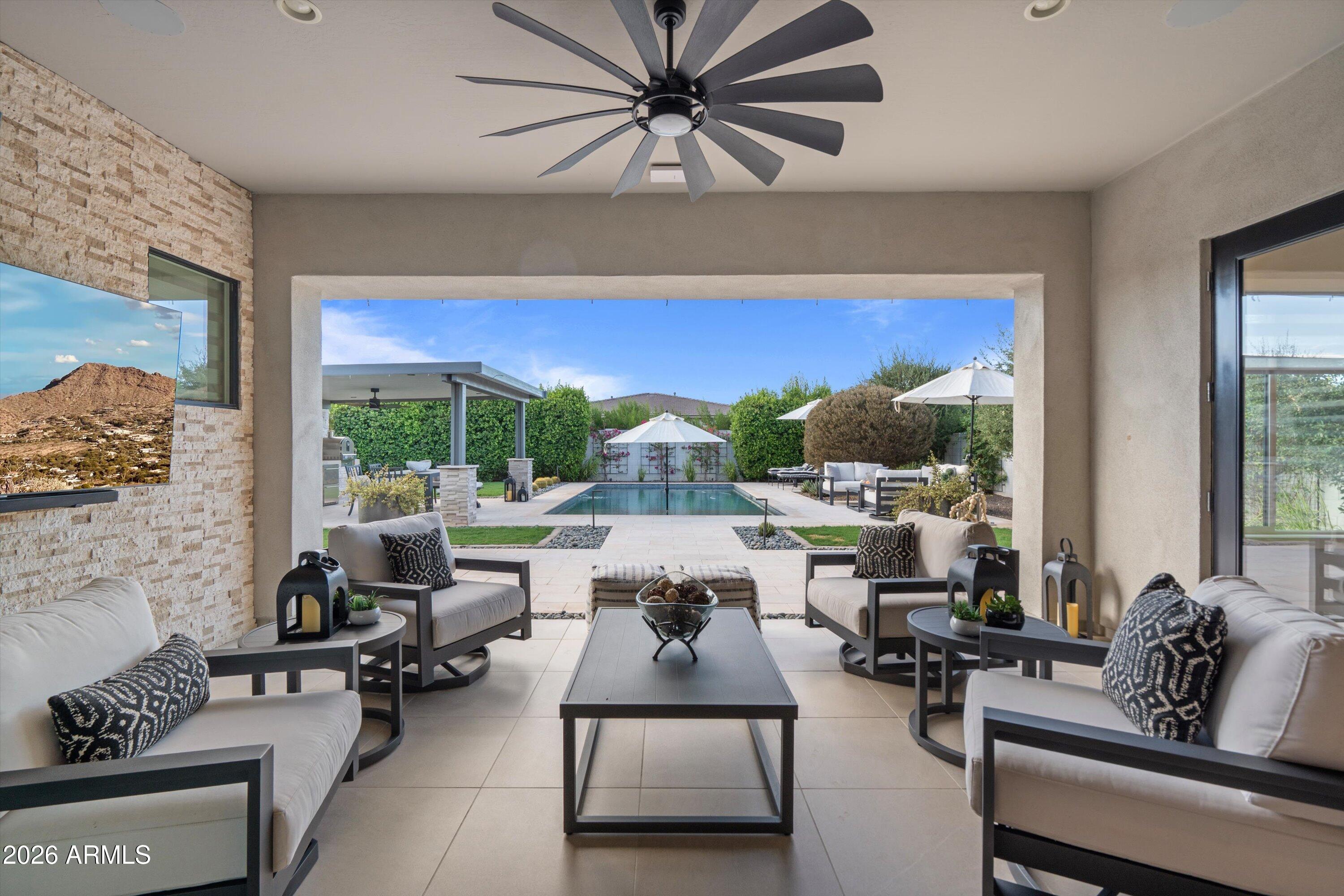 Welcome to 21876 E Sunset Drive, Caleda by Toll Brothers
This 3,317 sq ft residence behind the gates of Caleda delivers what new construction rarely can: a home that's already finished, furnished with intention, and ready to live in from day one.
Twelve-foot ceilings and abundant natural light set the tone the moment you walk in. The kitchen anchors the space with an oversized quartz island, double ovens, a built-in upgraded fridge, a pot filler, and custom cabinetry, a layout built for people who actually cook and entertain. Crown molding and shiplap accent walls carry a designer touch through the main living areas, while walk-in closets with custom built-ins keep every room functional as well as beautiful.
The details that don't show up in photos matter just as much here: dimmer switc on every light in the house, a brand-new front door, and custom window treatments, all electric, throughout.
Step outside through the oversized sliders and the entertaining continues. The backyard is a finished resort: outdoor kitchen, mature landscaping, and a pool with a chiller for year-round comfort. Surround sound carries from the interior living spaces straight out to the patio, so the party never has to stop at the door. Upgraded side gates create a private, secluded side yard you won't find in the standard floor plan.
Even the garage got the Caleda treatment: upgraded flooring, a modern garage door, custom paint, window treatments, a tankless water heater, and a built-in home gym.
This isn't a home you'll need to renovate, landscape, or wait on. It's done, and done with real intention.