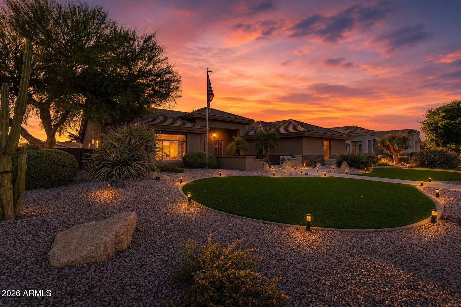 Located in the desirable Russell Ranch community, this single-story 4 bed / 3 bath semi-custom home sits on an exceptional 18,625 sq ft corner lot with no rear neighbors, mountain views, and a backyard designed to impress.

The outdoor space is a true showpiece: a custom putting green, mature palms, remote-controlled patio sunshades, built-in BBQ, and a stunning hand-painted mural that wraps the back wall -- each section depicting meaningful landscapes and stories. The west-facing orientation delivers nightly sunsets in shades of gold, orange, and pink, framed perfectly by the mountains and the art.

The floorplan is one of the home's strongest features -- a true split layout with generous room sizes, excellent flow, and spaces that feel open yet defined. The great room sits at the heart of the home with natural light, a stone fireplace, and built-in entertainment center, creating an easy gathering space. The kitchen opens directly to the living area and dining nook, making everyday living and entertaining seamless.

The primary suite is thoughtfully separated for privacy, while the additional bedrooms and full baths are positioned to offer flexibility for guests, multigenerational living, or a home office setup. With nearly 2,900 sq ft on a single level, the layout feels spacious, functional, and comfortable -- a rare combination in today's market.

The 3-car garage is a standout with epoxy floors, cabinets, its own mini-split system, a commercial-grade air compressor (included), and two newer garage door openers -- ideal for car enthusiasts or hobbyists.

Additional upgrades include: two A/C units (one new in 2023), Rheem water heater (2021), central vacuum, security system with cameras, RV gate with dedicated pad, wall niches with recessed lighting, a newer large storage shed, and all appliances including washer & dryer.

Just minutes to Loop 303, golf, dining, and shopping. Homes in Russell Ranch are limited -- and a lot with this privacy, space, and backyard experience is truly rare. Come see it in person and feel the difference for yourself.