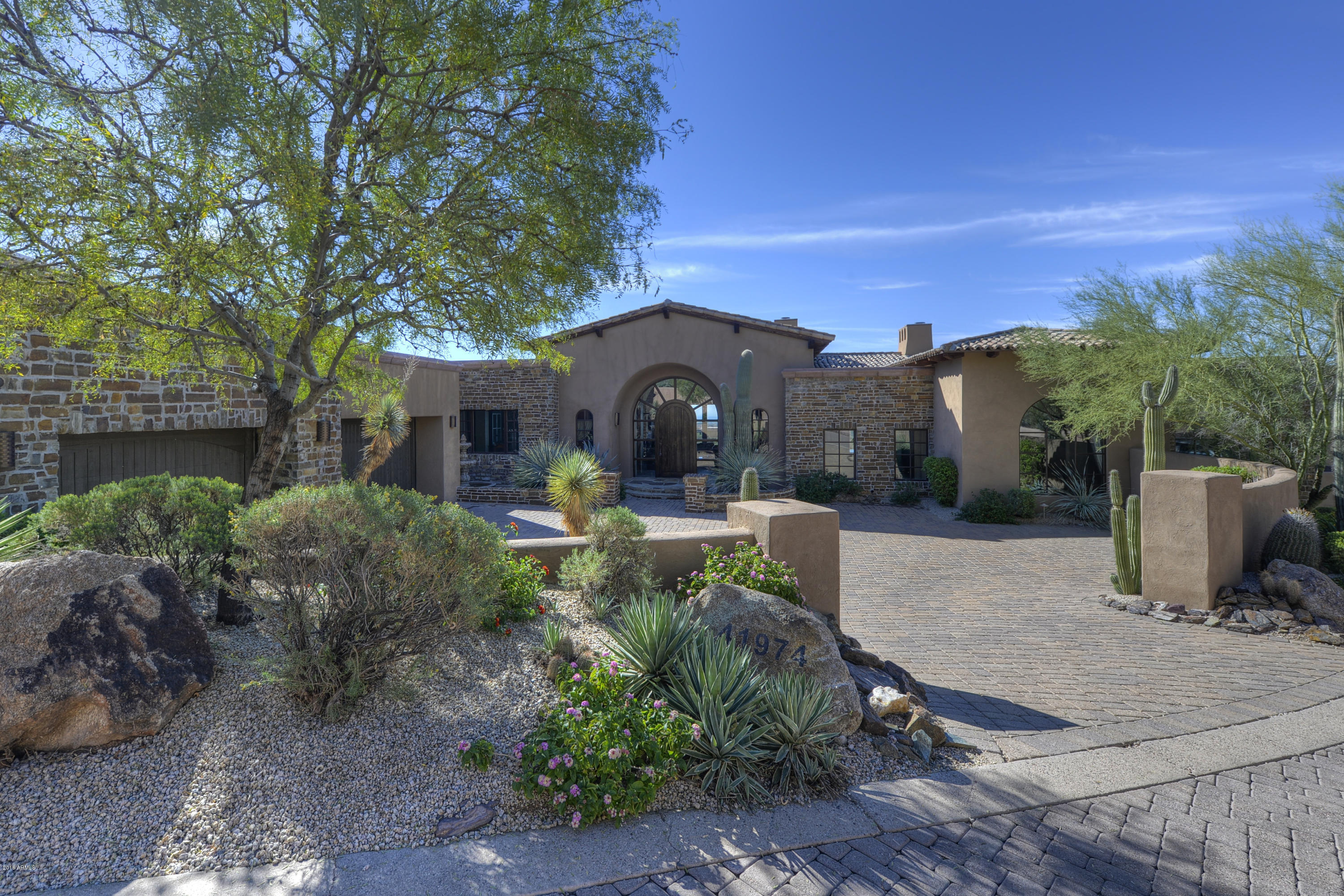 Fabulous Bing Hu European Estate home in Desert Mountain's Saguaro Forest village. Sweeping ridgetop golf, mountain and Valley views from the entire home and resort patio. Single level main home, with lower level billiard room, bar and home theater. Spacious, open great room and expansive covered patios are perfect for entertaining. Gourmet chef's kitchen with amazing custom cabinets, handsomely appointed library and simply elegant master suite.  Finely finished with custom details and quality designer finishes throughout. State-of-the-art Crestron and home automation. Sold completey furnished. All in the fabulous Desert Mountain Club with amenities for the entire active family. Strategically located for proximity to both urban amenities and Arizona's vast outdoor recreational areas.