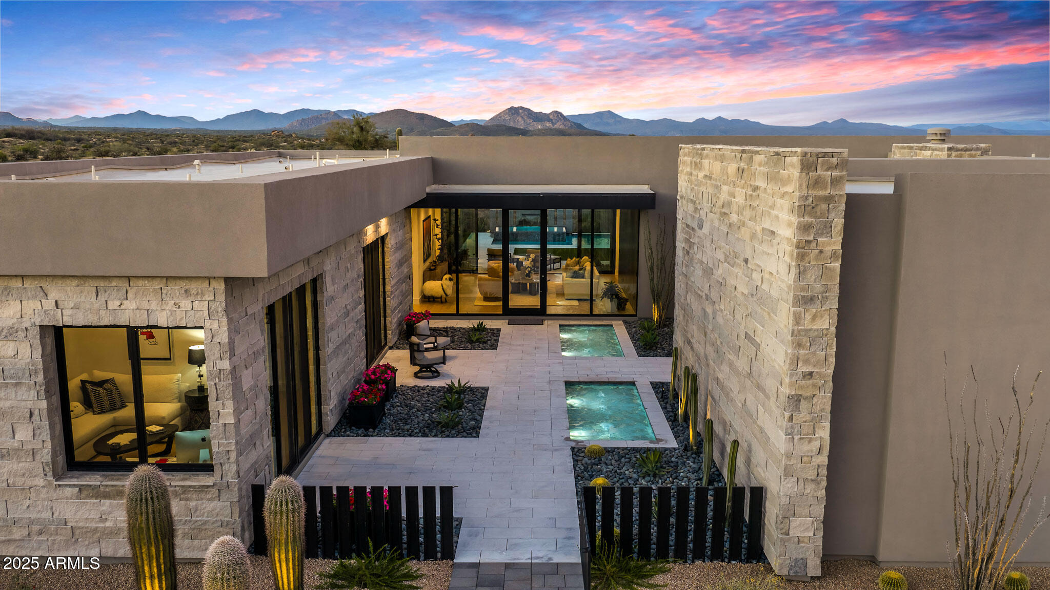 Embrace North Scottsdale living in this newly upgraded Shea Signature residence, set behind the double gates of The Signature at Storyrock. Positioned on the premier lot backing to 30,000+ acres of permanently protected McDowell Sonoran Preserve. Only months old and truly better than new this home offers rare privacy and uninterrupted desert and mountain views. Expansive walls of glass and 10' floor-to-ceiling windows create a refined indoor-outdoor connection, bringing natural light and the surrounding landscape into every space.
Designed for luxury and livability, the spacious great room centers around a gourmet kitchen featuring Wolf/Sub-Zero appliances, double wall ovens, professional gas range, large communal island, extensive cabinetry, and an oversized walk-in pantry. The primary suite captures stunning sunrise views and includes a spa-style bath with freestanding tub, large walk-in shower, and boutique-style closet. Two additional guest suites, each with its own private flex room and private patio provide exceptional comfort for visitors or multigenerational living.
Extensive upgrades elevate every corner of the property including the Savant smart-home system managing lighting, audio, climate, and custom shades throughout. Climate controlled 4-car garage, sparkling heated pool & spa, custom courtyard fountains, expansive hardscaping and desert-inspired landscaping are only some of the elegant designer finishes that complete this turnkey modern desert retreat.