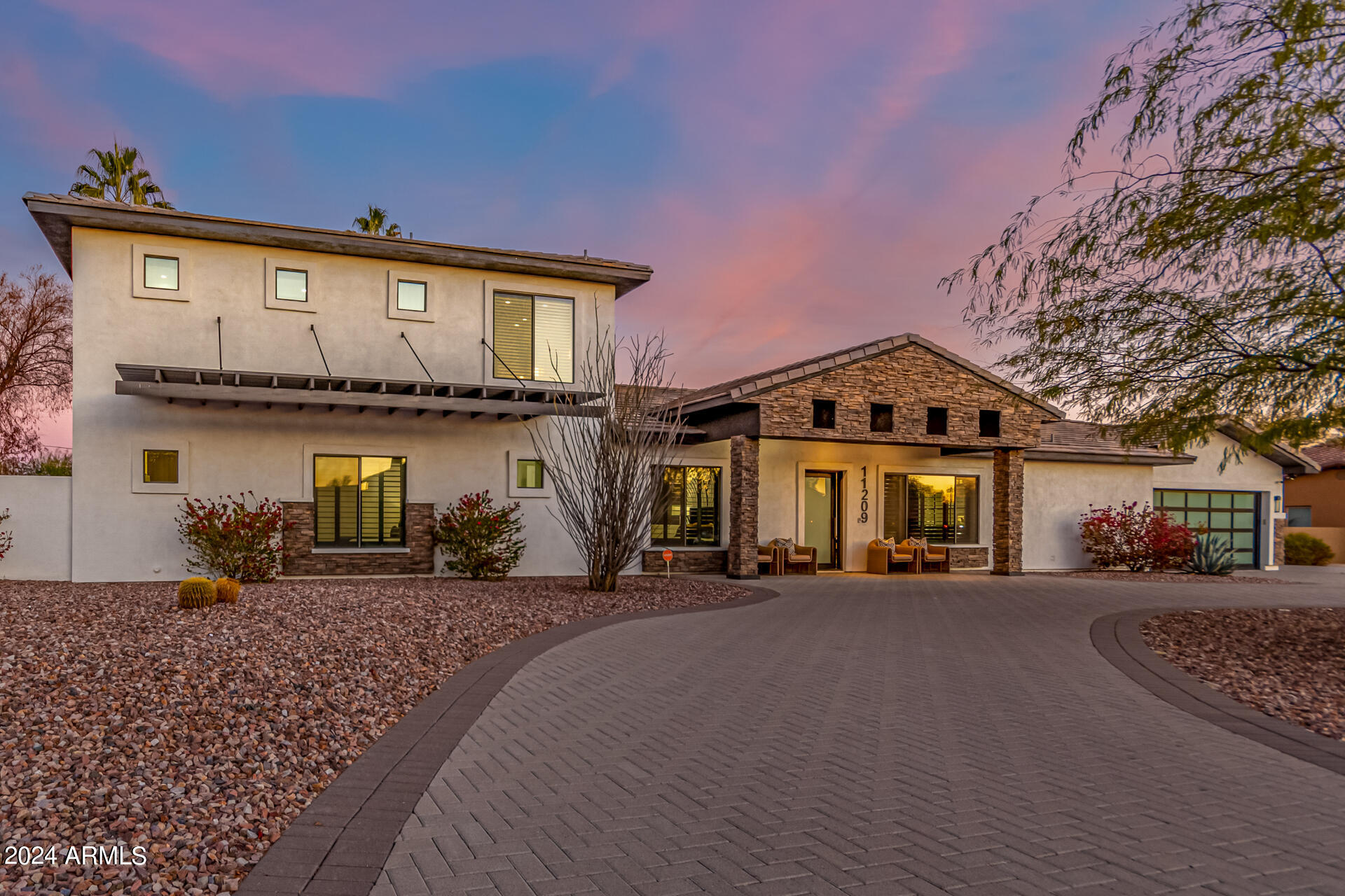 Fully furnished Retreat in the Heart of Scottsdale! This amazing 5 bed, 5 bath residence in Scottsdale is just the one for you! Nestled on a premium cul-de-sac lot, this stunning home boasts delightful stone accents, manicured desert landscape, circular paver driveway, a 4 car tandem garage, and an RV gate! Inside you will find a spacious open floor plan w/elegant wood-look flooring, crown molding, dazzling light fixtures, trending palette, a dry bar, plantation shutters by the dining area, and a linear fireplace to keep you warm! The chef's kitchen is comprised of ample cabinetry w/marble counters, herringbone tile backsplash, stainless steel appliances such as dual wall ovens, a walk-in pantry, and 2 islands, one with a lovely breakfast bar! Upstairs is the primary bedroom, boasting private balcony access, a walk-in closet, and a lavish ensuite w/dual sinks & a garden tub. Other bedrooms also boast their own walk-in closets for the convenience of your guests and loved ones! Finally, the expansive backyard includes a covered patio, extended seating area, artificial turf, a putting green, basketball court, a large gazebo w/a built-in BBQ, a convenient storage shed, and a sparkling blue pool/spa combo! This is the opportunity of a lifetime, act now!