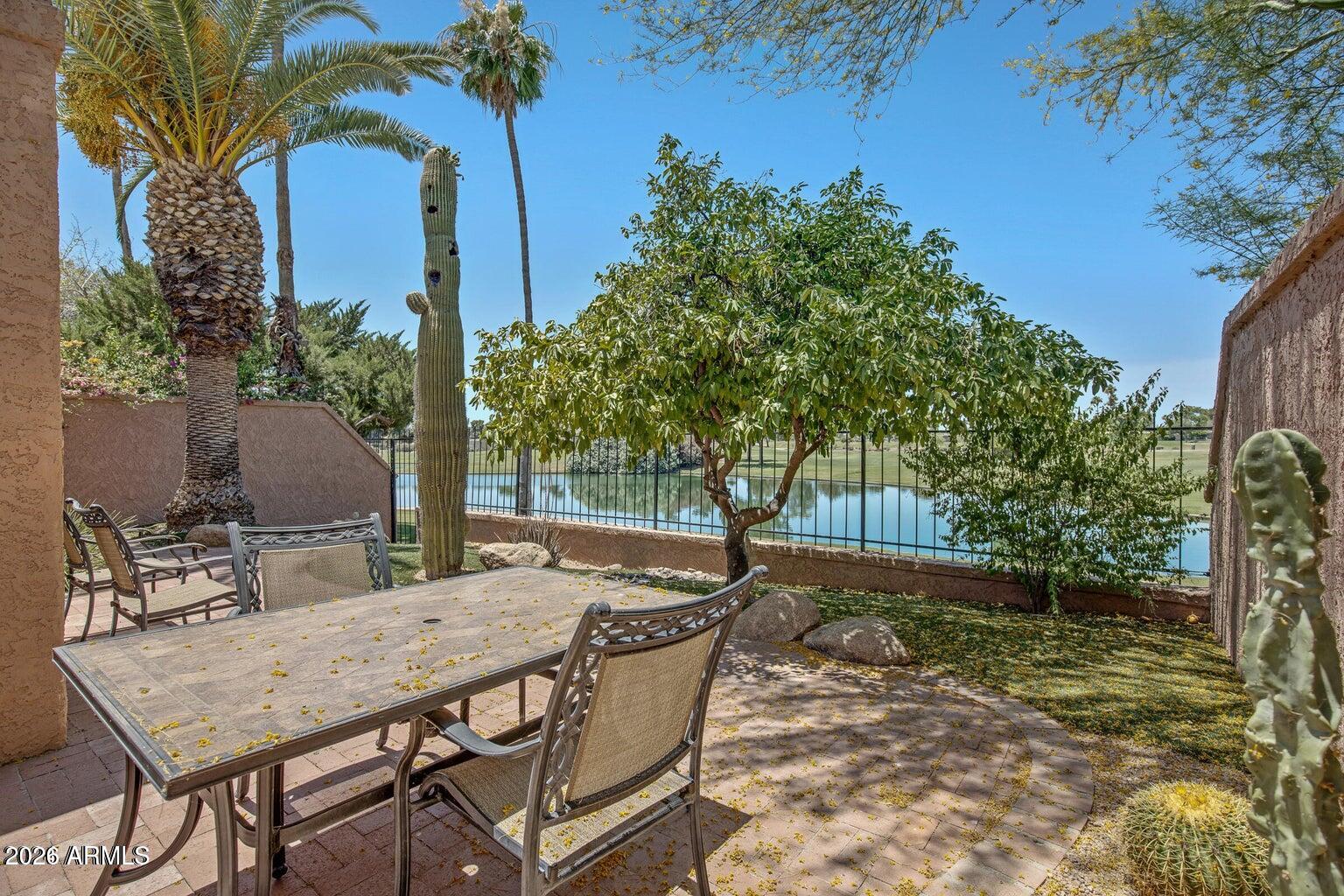 Waterfront luxury meets resort-style living in McCormick Ranch. This exceptional single-level patio home boasts direct gated access to the greenbelt and stunning, unobstructed views of the lake, Camelback, and Mummy Mountains. Relax on your private covered back patio, head a few homes down one of 2 community pools. Inside, a sunlit foyer with a skylight welcomes you into an expansive layout featuring a formal dining space and a gourmet eat-in kitchen with granite counters, stainless appliances, and a built-in wet bar with a wine cooler. The fireplace-warmed family room features beautiful wood-look tile and surround-sound speakers, while the split primary suite offers a private sanctuary with a large walk-in closet.