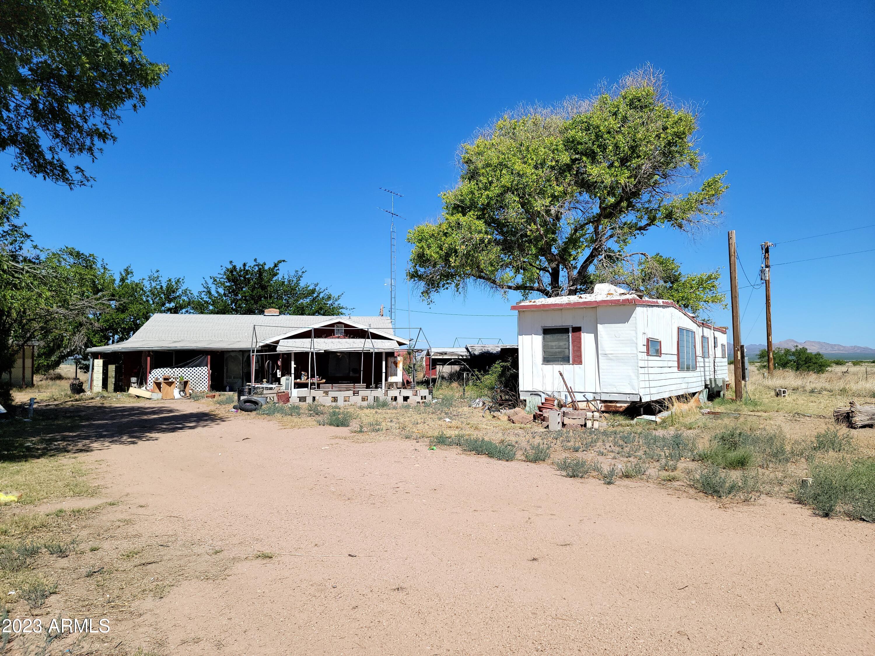 This property has so much potential. There are 80 level acres that are perfect for horses or other animals. The property is fenced and cross fences and has great views and a private residential type well. There are numerous outbuildings on the property. The home has 3 bedrooms and 2 baths. It also has newer forced air gas heat and a/c. The rest of the home is pretty original. There is also a sw  mobile home on the property. This property is being sold AS IS.