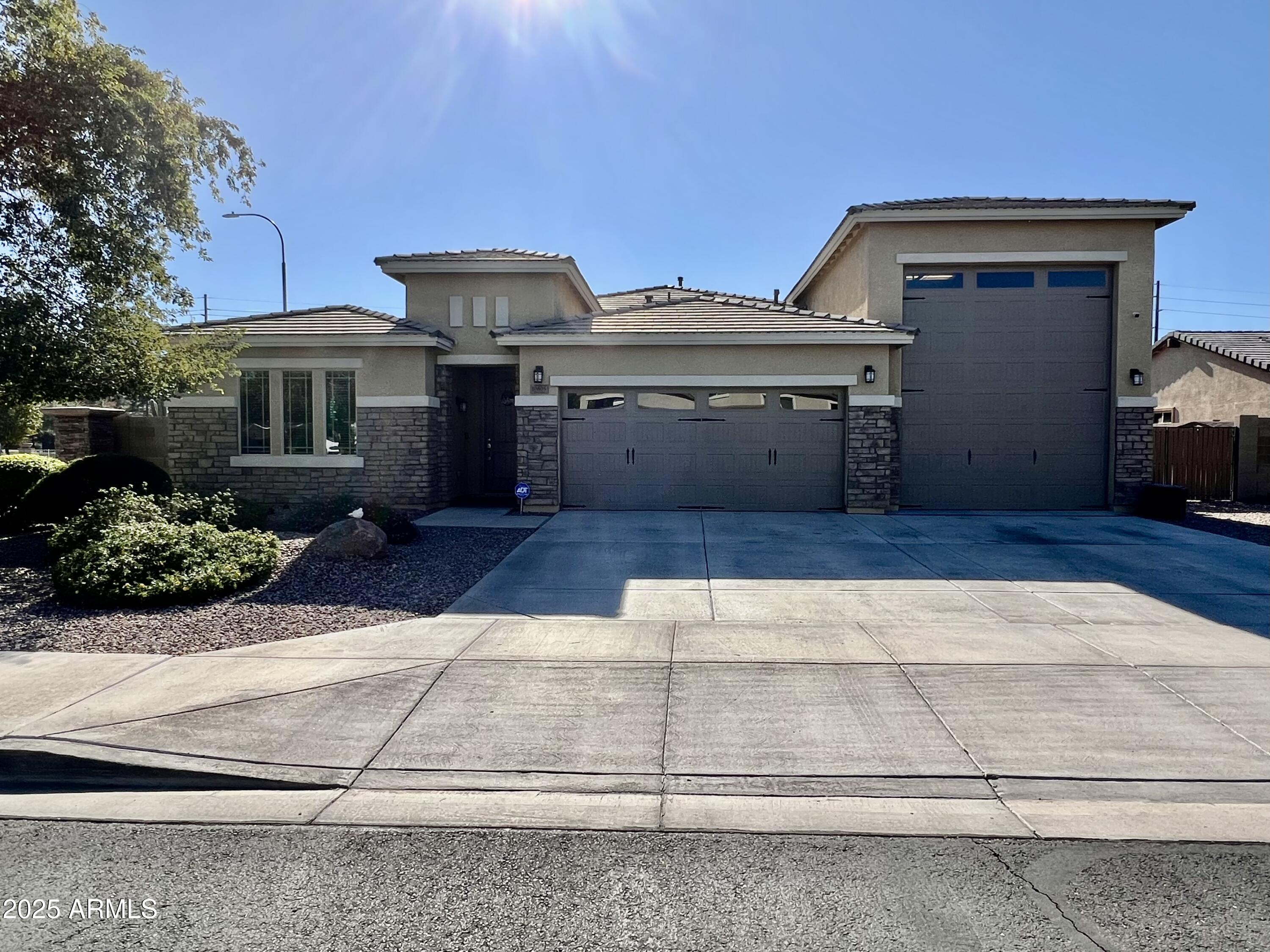 Don't miss this incredible opportunity to own a beautifully maintained 4 bedroom, 2.5 bath home that blends comfort, style, and thoughtful design. Wood looking tile extends through the main living areas, while the bedrooms offer soft carpet for added warmth. Enjoy formal living and dining rooms, along with a welcoming family room that flows into a spotless kitchen featuring granite countertops, generous cabinetry, and plenty of workspace. The exterior is just as impressive, offering an RV garage with durable epoxy floors, an RV gate, and a low-maintenance backyard with attractive synthetic grass. Ideally situated near the Westgate Entertainment District, shopping, restaurants, and more, this home delivers exceptional convenience, value, and everyday livability.