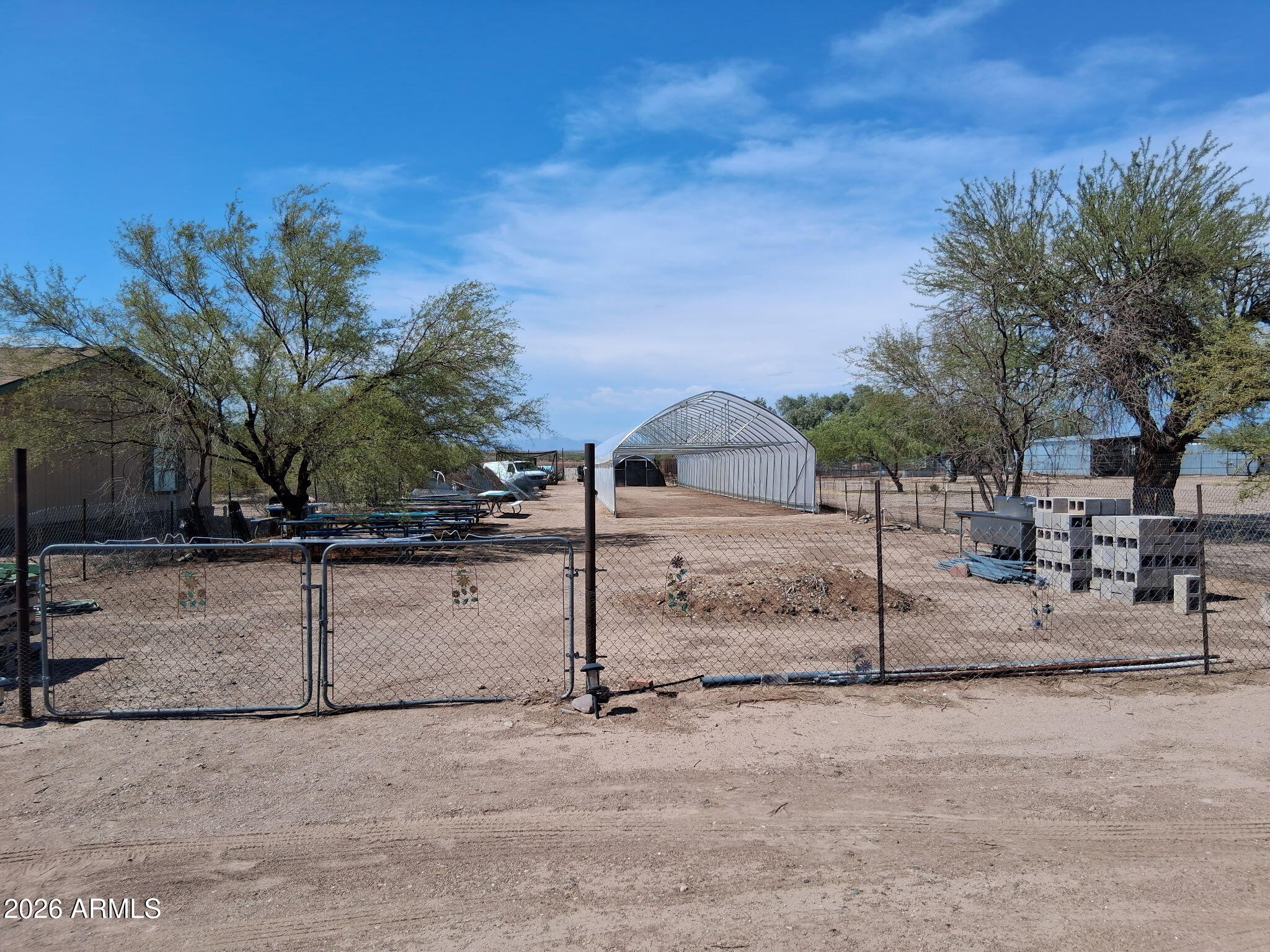 Unique Opportunity! Located on Butte Ave near Central, fenced lot available with two double gates. General Rural zoning suitable for residential construction, farming, livestock, nursery, Town of Florence water plus irrigation rights to San Carlos ditch. Currently has a high tunnel  120'' x 21'' which can convey with purchase.  Also stainless steel produce washing station with two sinks and an equipment shed. Soil has been enriched for 15 years for organic produce. Lots of options! Owner/Agent.